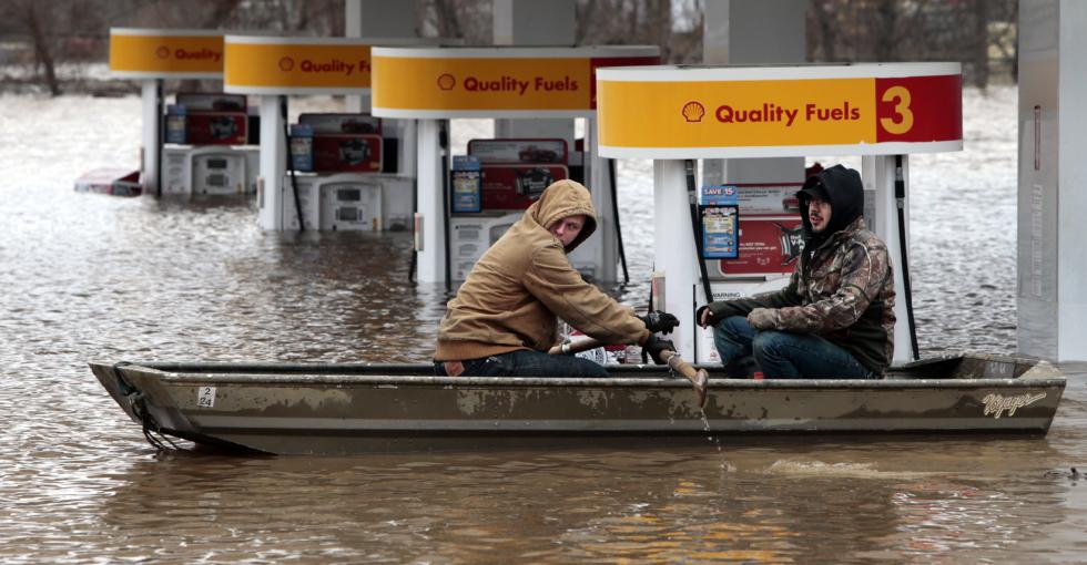 Paul Dusablon, left, and Richard Kotva row from the Circle K at Springdale Park after helping the owner move electronics off the floor inside the convenience store, in Fenton, Mo., Wednesday, Dec. 30, 2015. A rare winter flood threatened nearly two dozen federal levees in Missouri and Illinois as rivers rose, prompting evacuations in several places. (Robert Cohen/St. Louis Post-Dispatch via AP) EDWARDSVILLE INTELLIGENCER OUT; THE ALTON TELEGRAPH OUT - Robert Cohen | St. Louis Post-Dispatch
