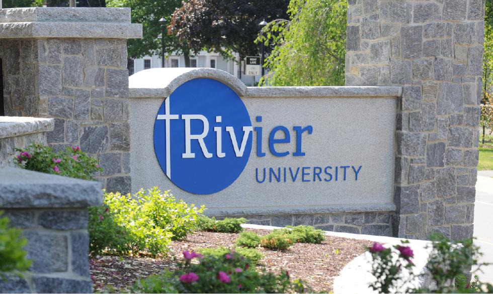 In this undated handout photo provided by Rivier University, the colleges' sign is seen at the entrance to the campus in Nashua, N.H. The small private university is promising students that they will get jobs within nine months of graduation. If not, Rivier University will pay the students' federally subsized student loans for up to a year, or enroll them in up to six master's degree courses for free. (Jodie Andruskevich/Rivier University via AP) - Jodie Andruskevich | Rivier University