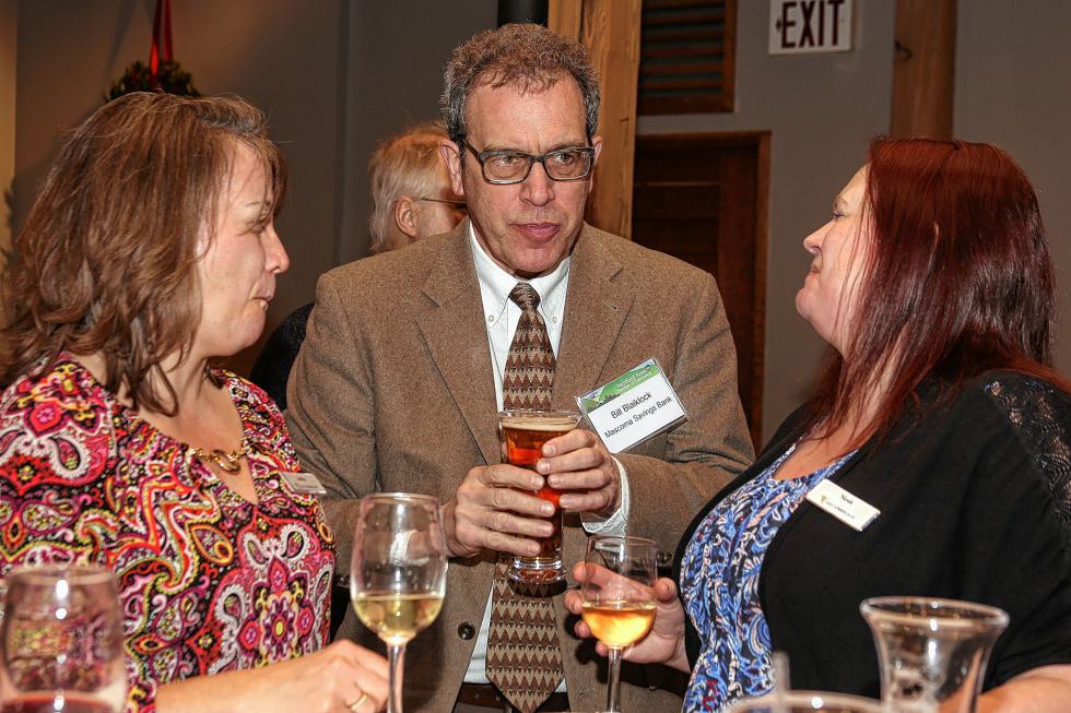 Andrea Brown, a teller with Lake Sunapee Bank, Bill Blaiklock, a branch manager at Mascoma Savings Bank, and Lake Sunapee Bank branch manager Nichole Dexter talk at the Chamber-to-Chamber mixer on Feb. 10 at Simon Pearce in Quechee, hosted by the Woodstock Area Chamber of Commerce and the Hartford Area Chamber of Commerce. (Gloria Towne photograph/allaroundtowne.com) - Gloria Towne |