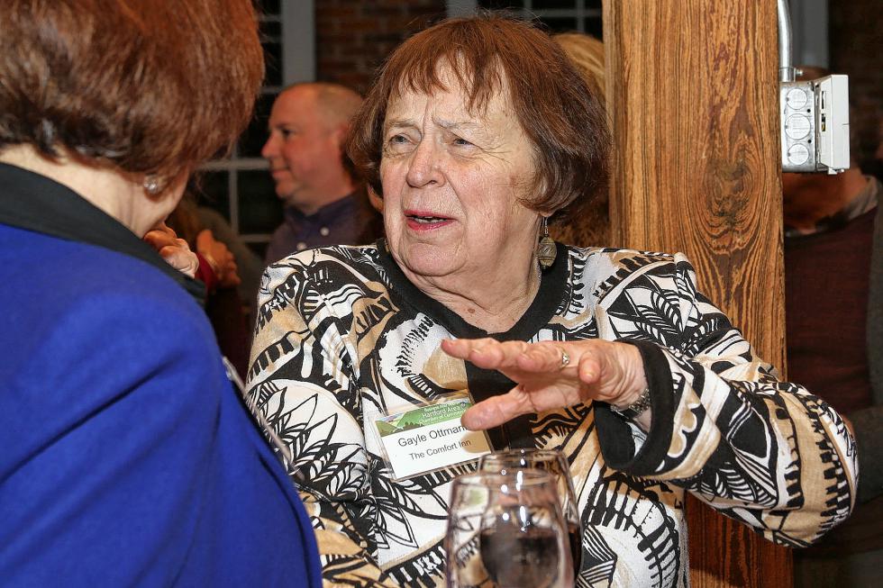 Gayle Ottmann speaks with Nancy Russel at the Chamber-to-Chamber mixer on Feb. 10 at Simon Pearce in Quechee, hosted by the Woodstock Area Chamber of Commerce and the Hartford Area Chamber of Commerce. (Gloria Towne photograph/allaroundtowne.com) - Gloria Towne |