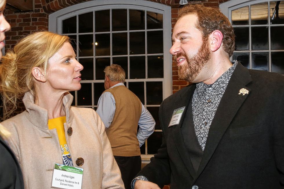 Jonathan Verge, of Gatherwoool Theatre Company, speaks with Andrea Agan of the Courtyard Residence Inn  at the Chamber-to-Chamber mixer on Feb. 10 at Simon Pearce in Quechee, hosted by the Woodstock Area Chamber of Commerce and the Hartford Area Chamber of Commerce. Verge offered 16 theater tickets as a raffle prize. (Gloria Towne photograph/allaroundtowne.com) - Gloria Towne |