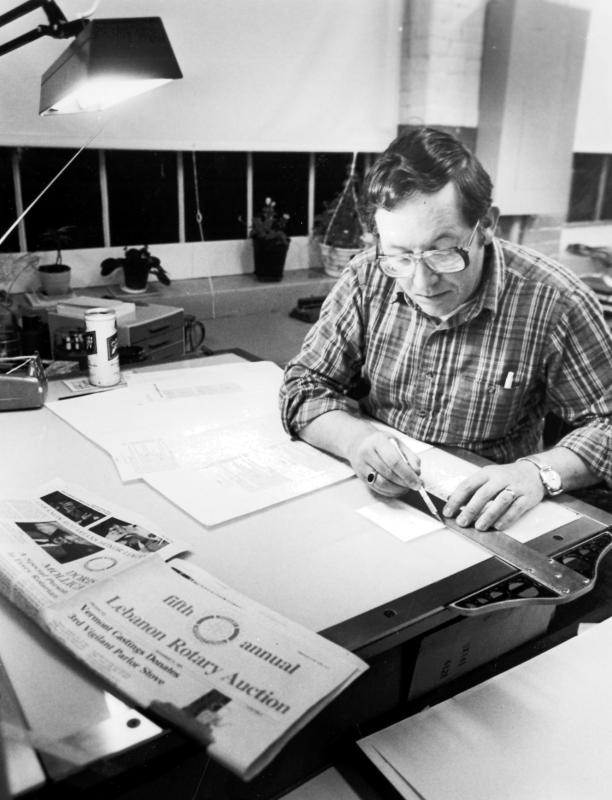 Paul Boucher works on the Lebanon Rotary Club's annual auction guide at Whitman Press in a photograph from 1982. (Valley News photograph) -