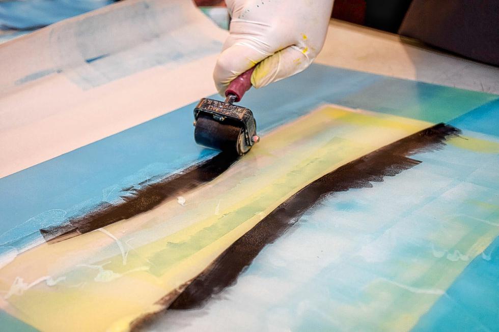 Printmaker Patty Castellini uses a roller called a brayer to spread paint on an acrylic plate. (Nancy Nutile-McMenemy photograph/www.photosbynanci.com) -