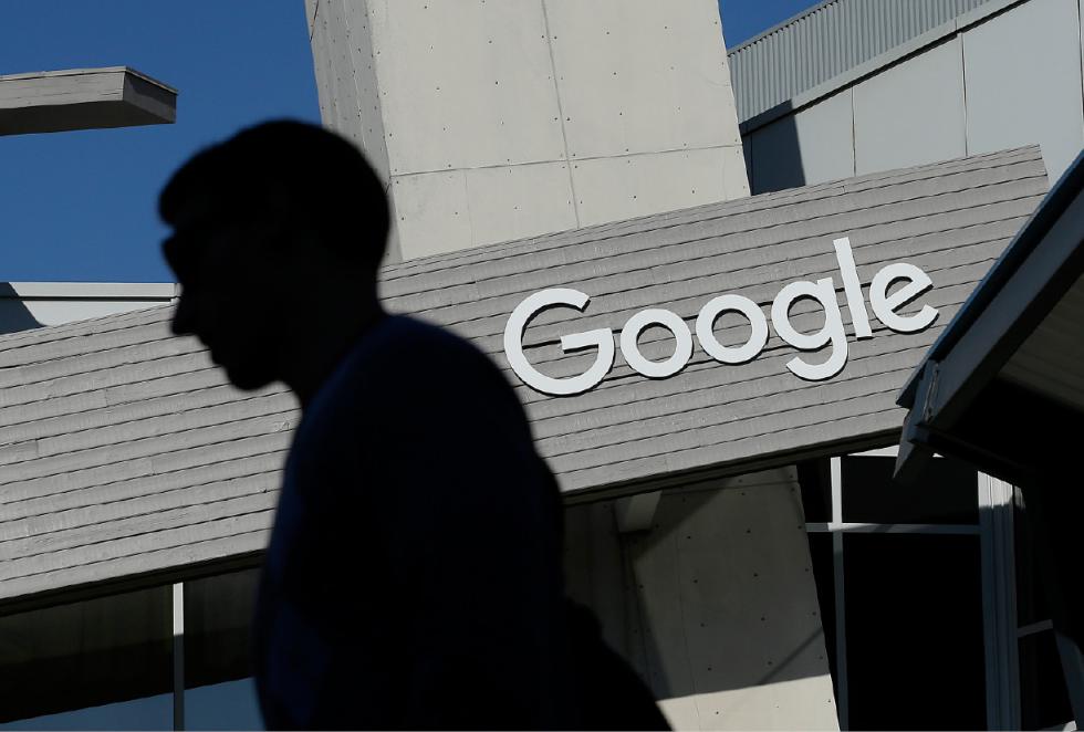 FILE - In this Nov. 12, 2015, file photo, a man walks past a building on the Google campus in Mountain View, Calif. Alphabet Inc., Google's holding company, reports financial results Monday, Feb. 1, 2016.  (AP Photo/Jeff Chiu, File) - Jeff Chiu | AP