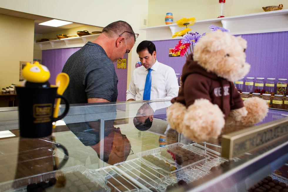 Republican presidential candidate Sen. Marco Rubio (center) of Florida buys chocolate from Central Sweets Candy Shop owner Tom Charbono in Franklin on Wednesday, Aug. 26, 2015.  (ELIZABETH FRANTZ / Monitor staff) - ELIZABETH FRANTZ | Concord Monitor