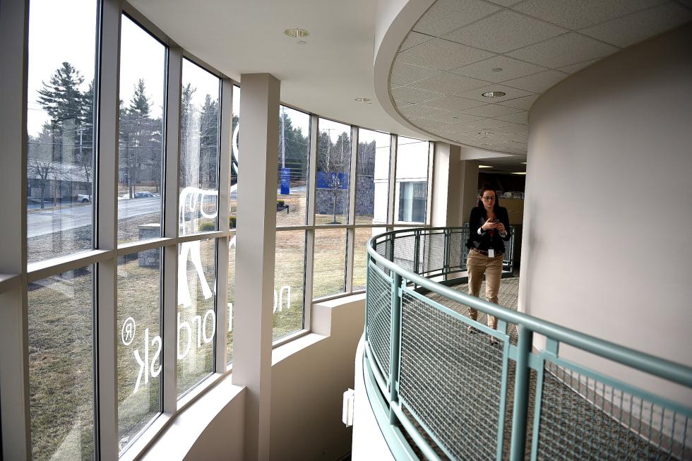 Employee Maria Beckmann, of Denmark, checks her phone while walking down a hallway at Novo Nordisk in West Lebanon, N.H., on March 16, 2016.  (Valley News - Jennifer Hauck) <p><i>Copyright Â© Valley News. May not be reprinted or used online without permission. Send requests to permission@vnews.com.</i></p> - Jennifer Hauck | Valley News