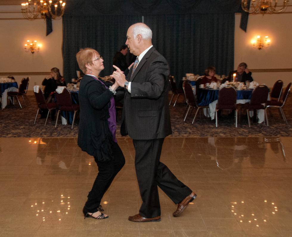 Arleen and Steve Rutledge, co-owners of Bridgman’s Fine Home Furnishings, dance to the music of Gerry Grimo’s 10-piece orchestra at the Lebanon Area Chamber of Commerce's 100th anniversary celebration on Friday, March 4, 2016, at the Fireside Inn & Suites in West Lebanon. (Medora Hebert photograph) -