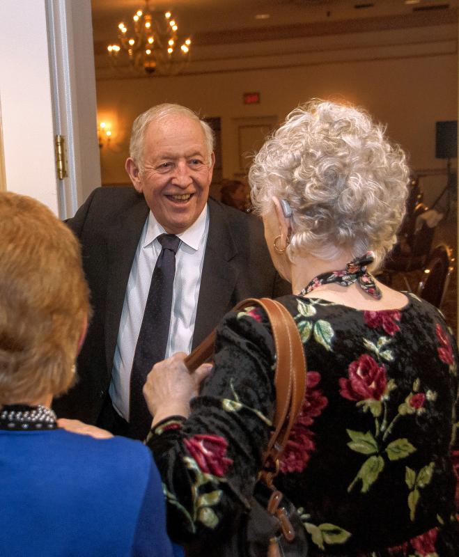 Paul Boucher  president and CEO of the Lebanon Area Chamber of Commerce, greets guests at the Chamber's 100th anniversary on Friday, March 4, 2016, at the Fireside Inn & Suites in West Lebanon. Boucher, 71, plans to step down in June after nearly 42 years of service to the Chamber. (Medora Hebert photograph) -