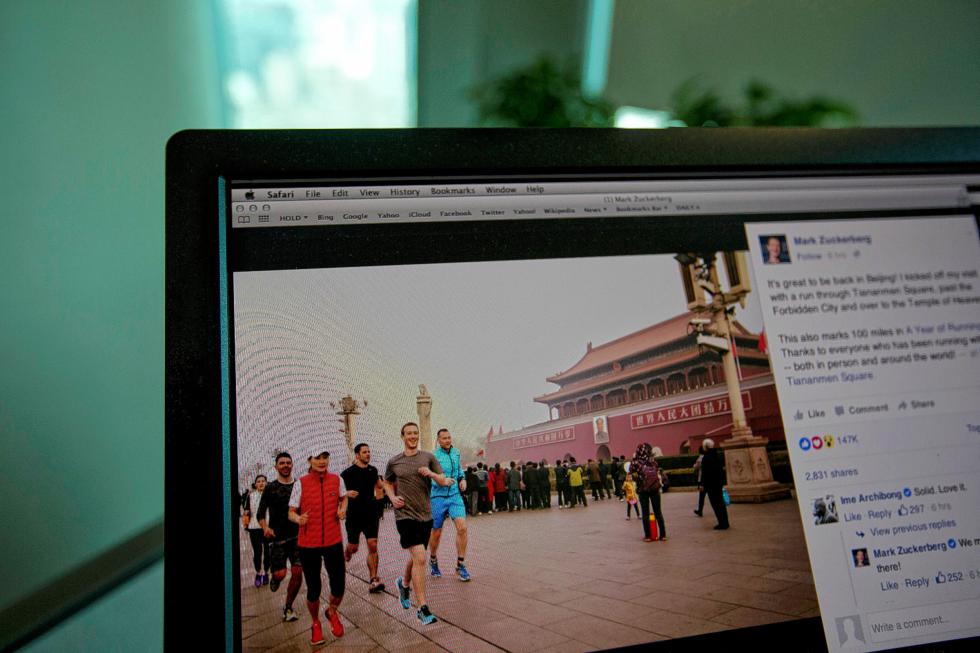 A computer screen displays the social media posting by Mark Zuckerberg on Facebook in Beijing, China, Friday, March 18, 2016. The photo of Facebook founder Mark Zuckerberg jogging in downtown Beijings notorious smog has prompted a torrent of astonishment, mockery and amusement on Chinese social media. (AP Photo/Ng Han Guan) - Ng Han Guan | AP