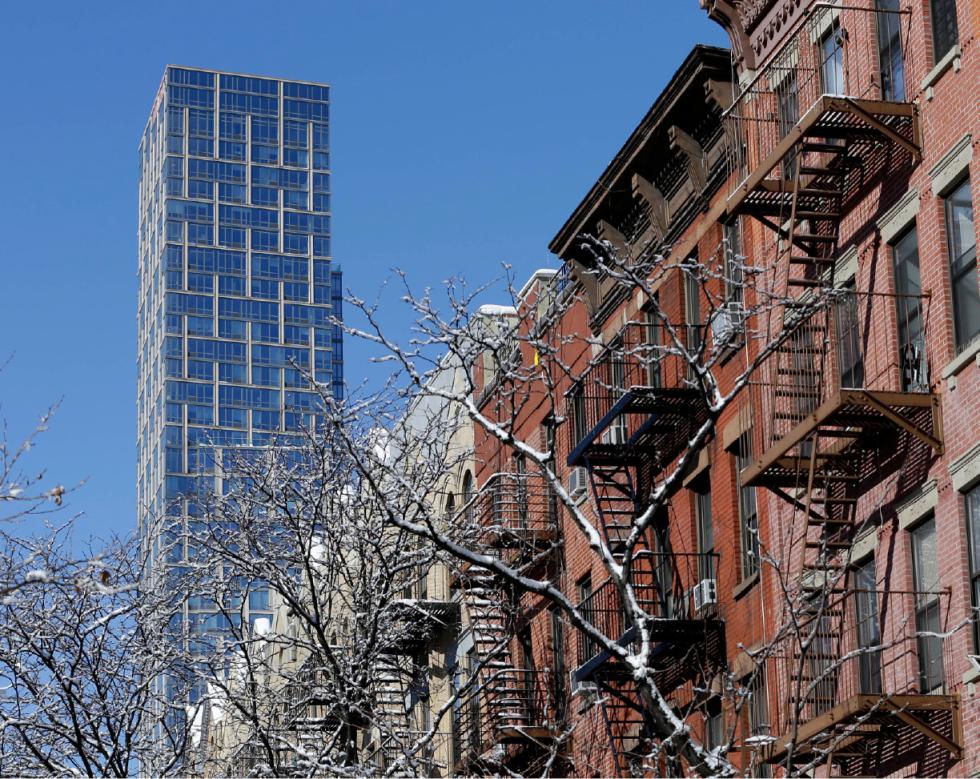 FILE- In this Feb. 13, 2015, file photo, a luxury rental building rises high above other residential buildings in the East Harlem section of New York. The number of renters grew faster on the outskirts of the nation's 11 most populous cities than within them between 2006 and 2014, New York University's Furman Center real estate think tank and bank Capital One found in a report released Tuesday. (AP Photo/Seth Wenig, File) - Seth Wenig | AP