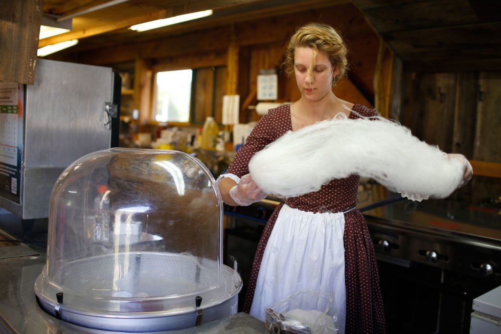 In one swift motion, Alyssa Fontaine, of Corinth, Vt., removes and bags maple-flavored cotton candy at the Orange County Maple Producers Association's building during Vermont History Expo 2016 in Tunbridge, Vt., on June 18, 2016. Fontaine and others put together 6,000 bags during the Tunbridge Fair. Founded 100 years ago, the non-profit organization promotes maple research and education and gives college scholarships to area high school seniors. (Valley News - Geoff Hansen) Copyright Valley News. May not be reprinted or used online without permission. Send requests to permission@vnews.com.