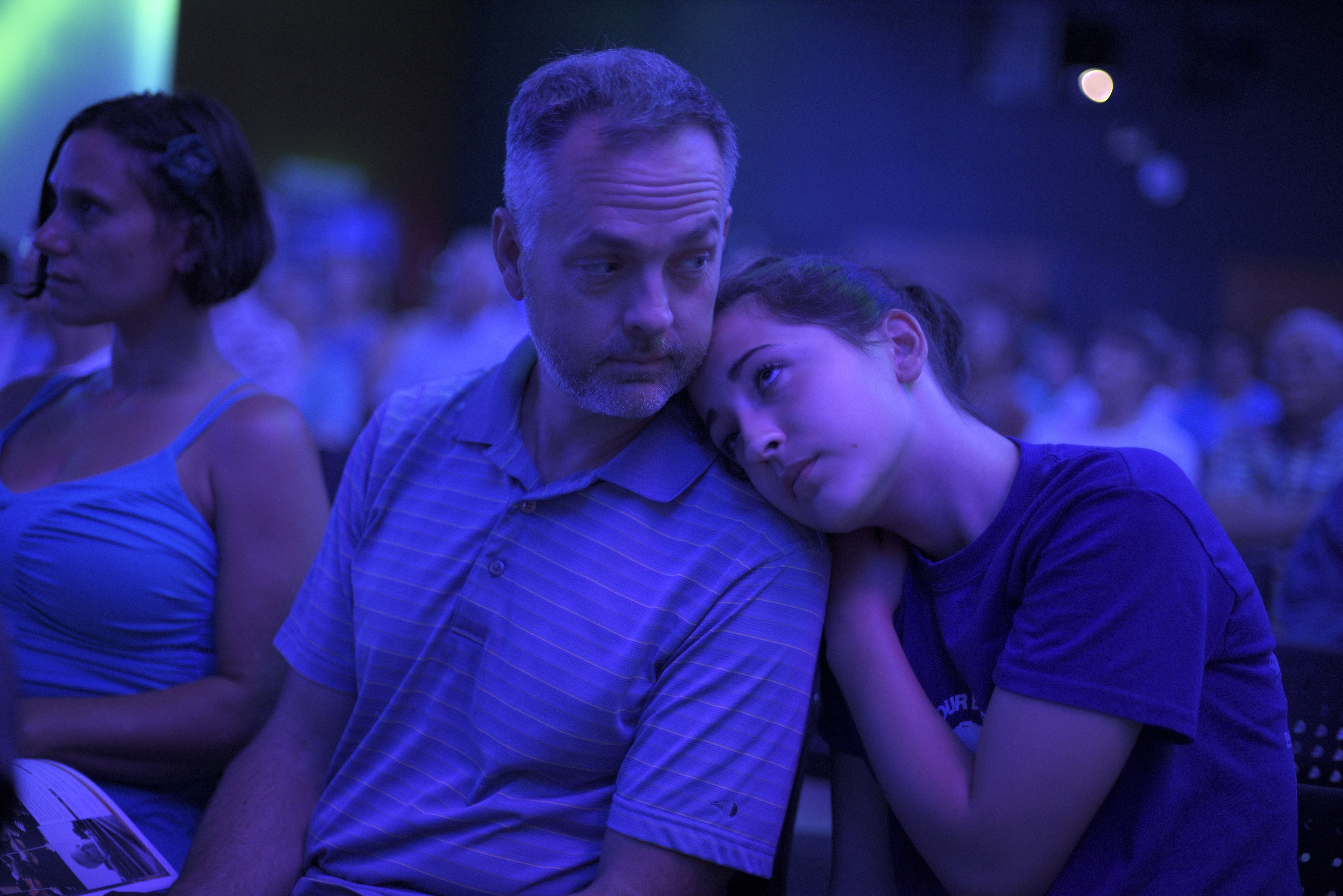 Molly Schutzius, of Lebanon, rests on her father, Tom Schutzius, during the Hopkins Center season launch party in Alumni Hall in Hanover, N.H. Thursday, July 14, 2016. (Valley News - James M. Patterson) Copyright Valley News. May not be reprinted or used online without permission. Send requests to permission@vnews.com.