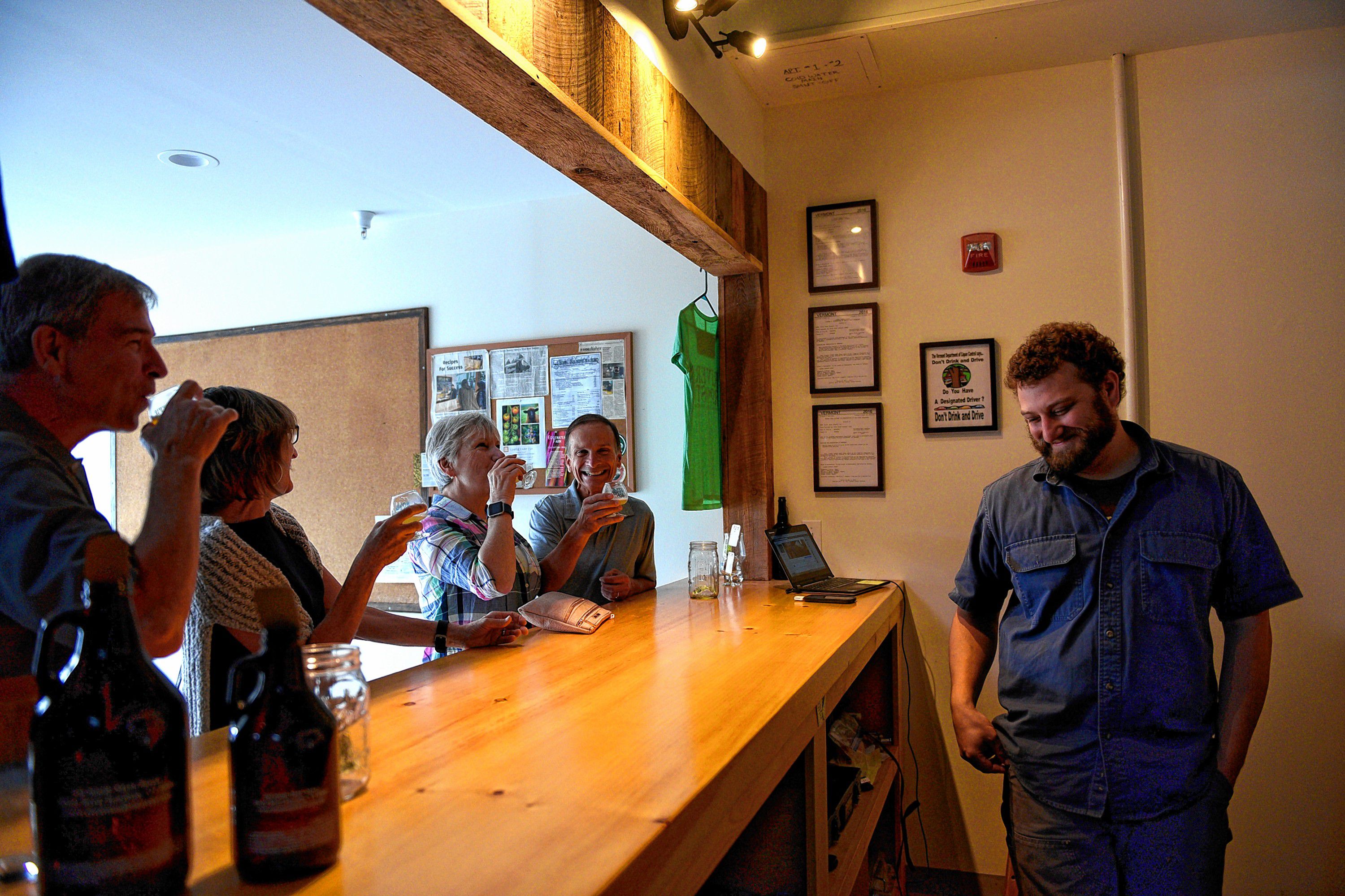 Doug Larison, left, his wife, Renee Larison; Dawn Larison and her husband, Ted Larison, all from Cortland, N.Y., all sample beer from River Roost Brewery in White River Junction, Vt., on Sept. 14, 2016. Brewery owner Mark Babson is pouring the samples. (Valley News - Jennifer Hauck) Copyright Valley News. May not be reprinted or used online without permission. Send requests to permission@vnews.com.
