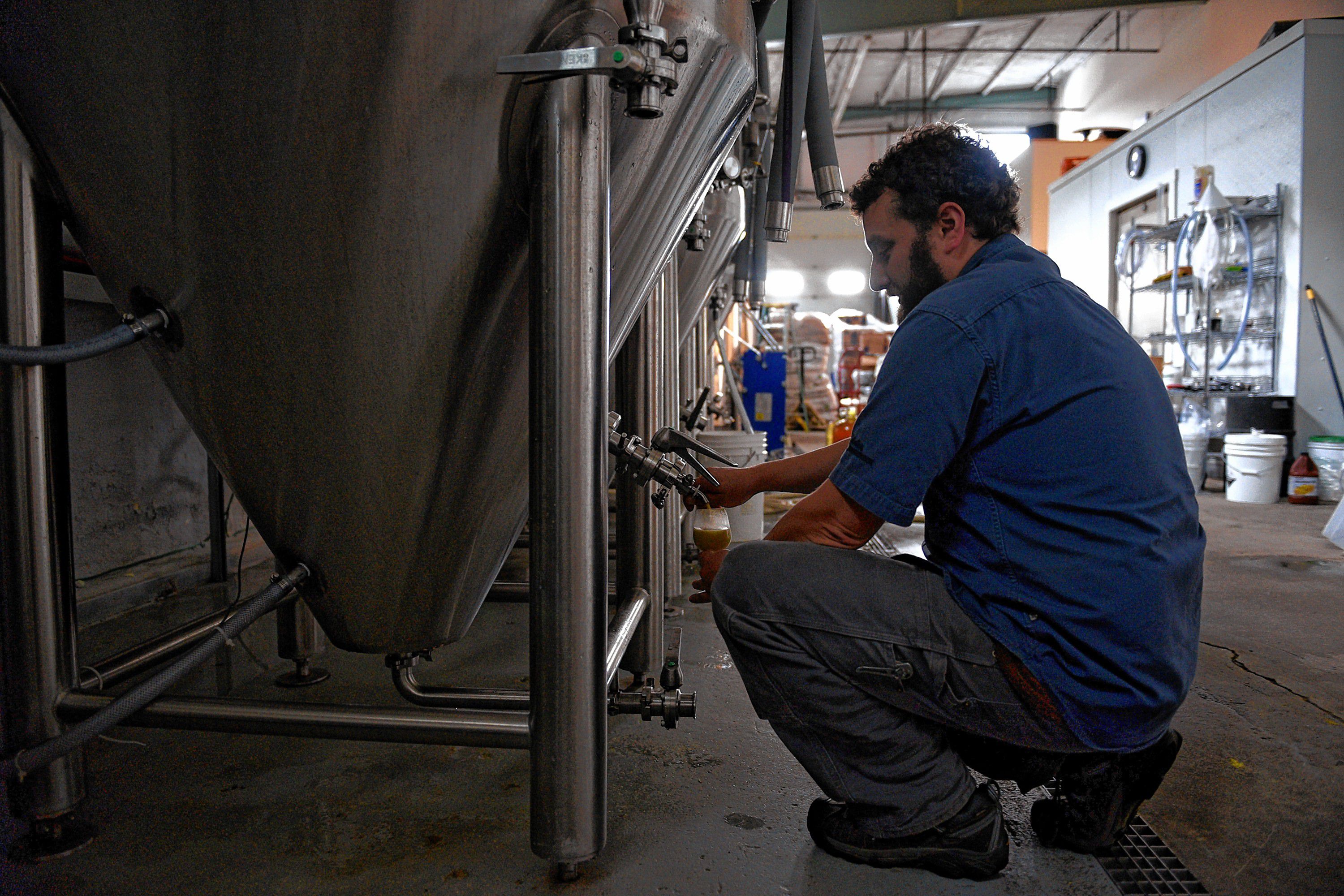Mark Babson of River Roost Brewery checks on a recently made beer at the brewery on Sept. 14, 2016, in White River Junction, Vt. (Valley News - Jennifer Hauck) Copyright Valley News. May not be reprinted or used online without permission. Send requests to permission@vnews.com.