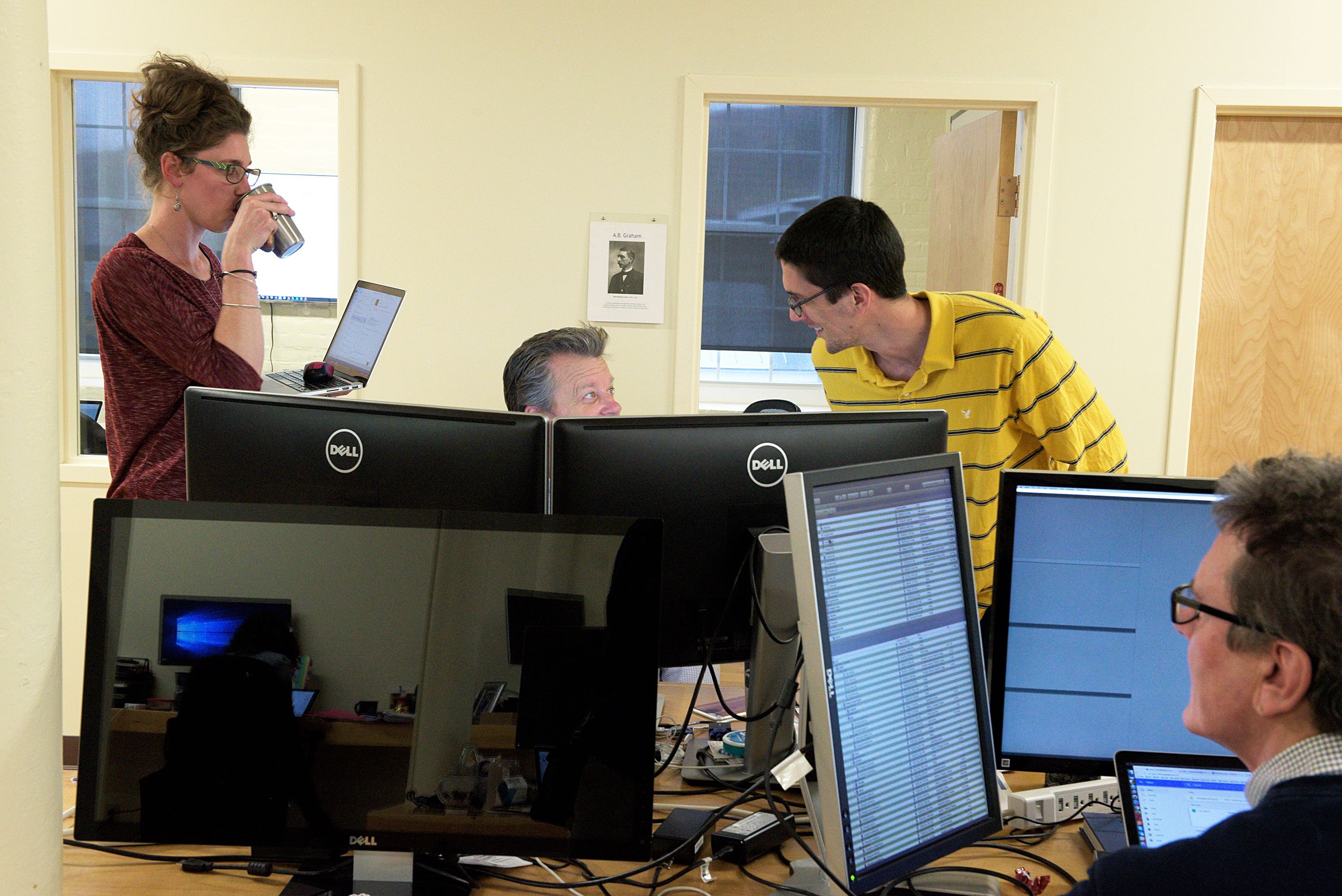 Product manager Josh Goodrich, back right, and account manager Alison Bowen, left, works with Vice President of Customer Success Mark Amdahl, middle, at Appcast in Lebanon, N.H., Thursday, October 27, 2016. Chief Scientist Mark Florence is at foreground right. (Valley News - James M. Patterson) Copyright Valley News. May not be reprinted or used online without permission. Send requests to permission@vnews.com.