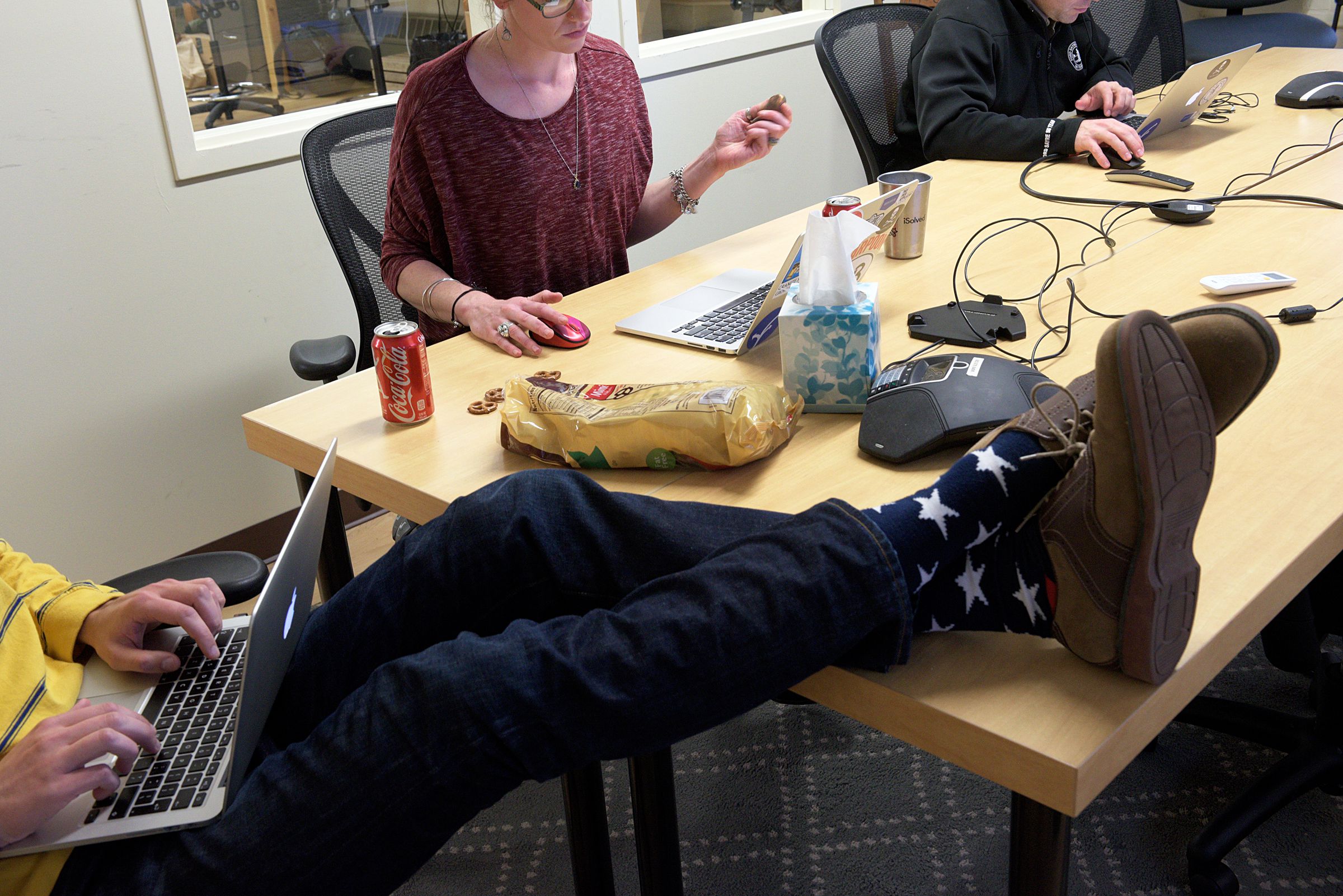 Product manager, Josh Goodrich, left, kicks up his feet while working with account manager Alison Bowen, middle, and manager of publisher operations Brian Garfield, right, at Appcast in Lebanon, N.H., Thursday, October 27, 2016. Appcast serves as a digital medium between large employers and publishers of job ads, Thursday October 27, 2016. (Valley News - James M. Patterson) Copyright Valley News. May not be reprinted or used online without permission. Send requests to permission@vnews.com.