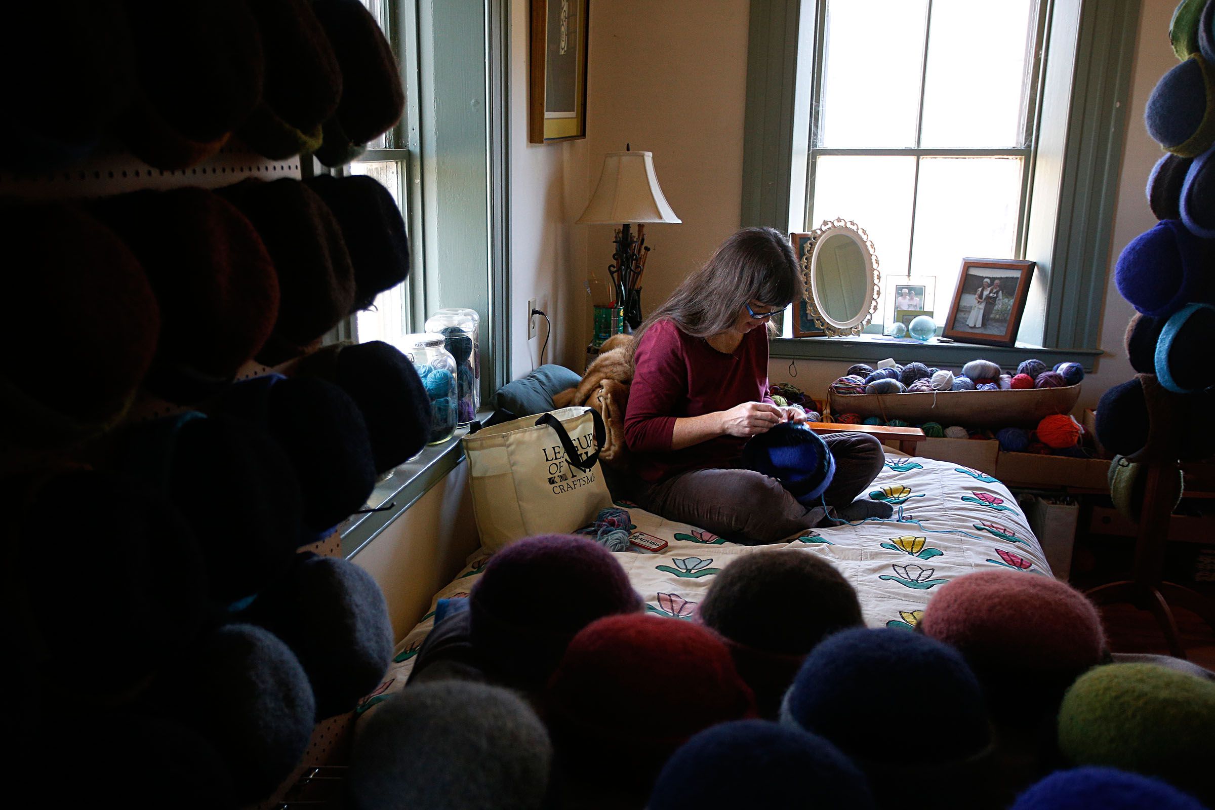 : HAT HANDIWORK Carrie Cahill Mulligan embroiders a hand-knit hat in her home studio. She started making the hats in 2000, while she was living in Alaska.