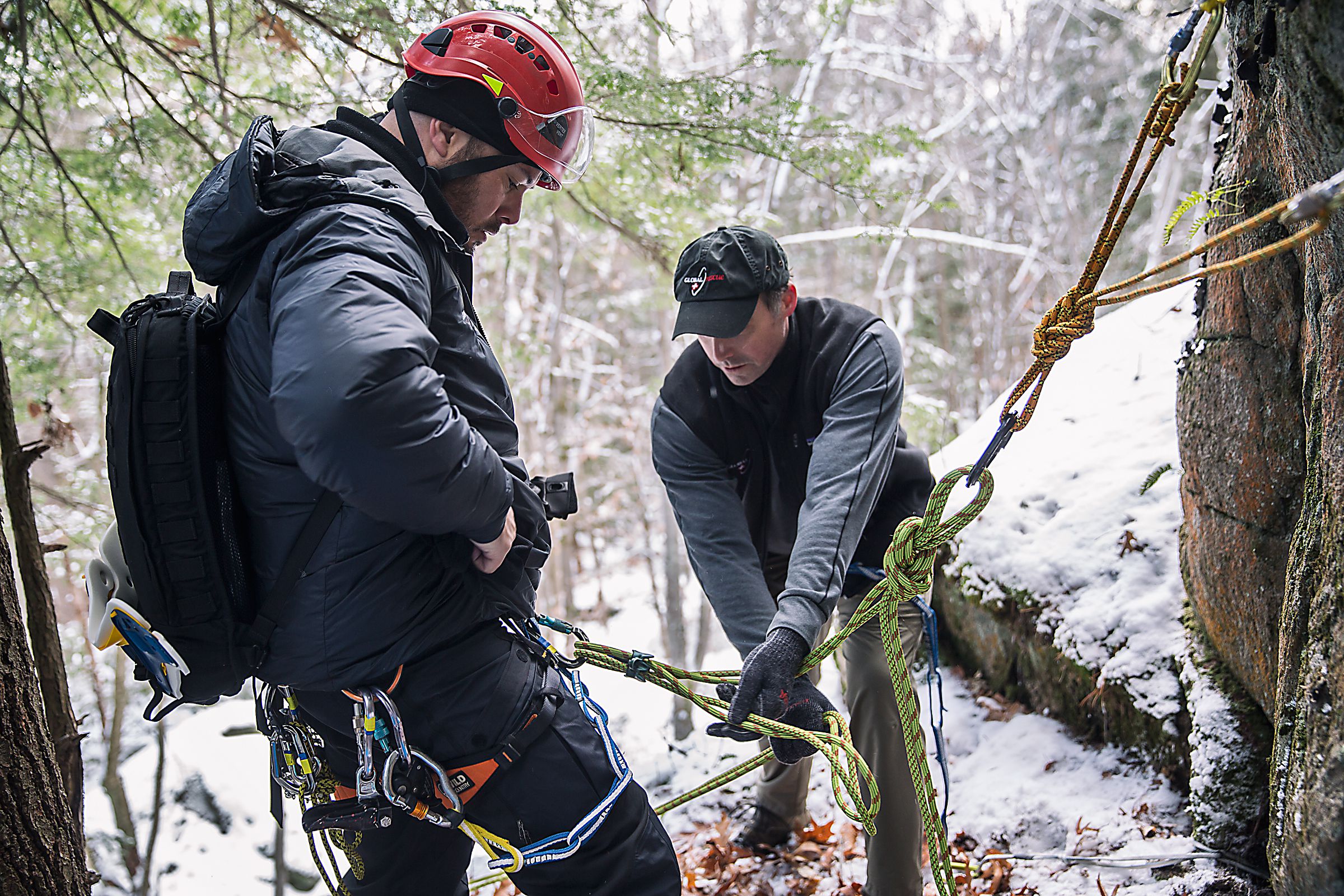Drew Pache, left, of Norwich, Vt., Senior Manager for Security Operations at Global Rescue, helps to secure Dave Keaveny, a medical specialist and an advanced EMT, during a training exercise in Lebanon, N.H., on Friday, December 9, 2016. The training exercise was to simulate the treatment and evacuation of a wounded climber from a remote location. (Valley News - John Happel) Copyright Valley News. May not be reprinted or used online without permission. Send requests to permission@vnews.com.