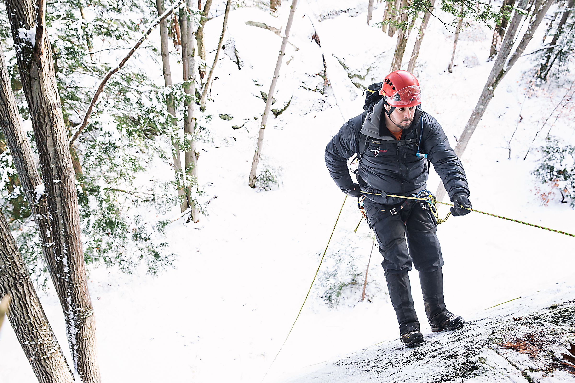 Dave Keaveny, of Canaan, N.H., a medical specialist and advanced EMT with Global Rescue, repels down to a wounded climber below during a training exercise in Lebanon, N.H., on Friday, December 9, 2016. Keaveny comes from a background in ski patrol, ambulance services, and wilderness search and rescue. (Valley News - John Happel) Copyright Valley News. May not be reprinted or used online without permission. Send requests to permission@vnews.com.