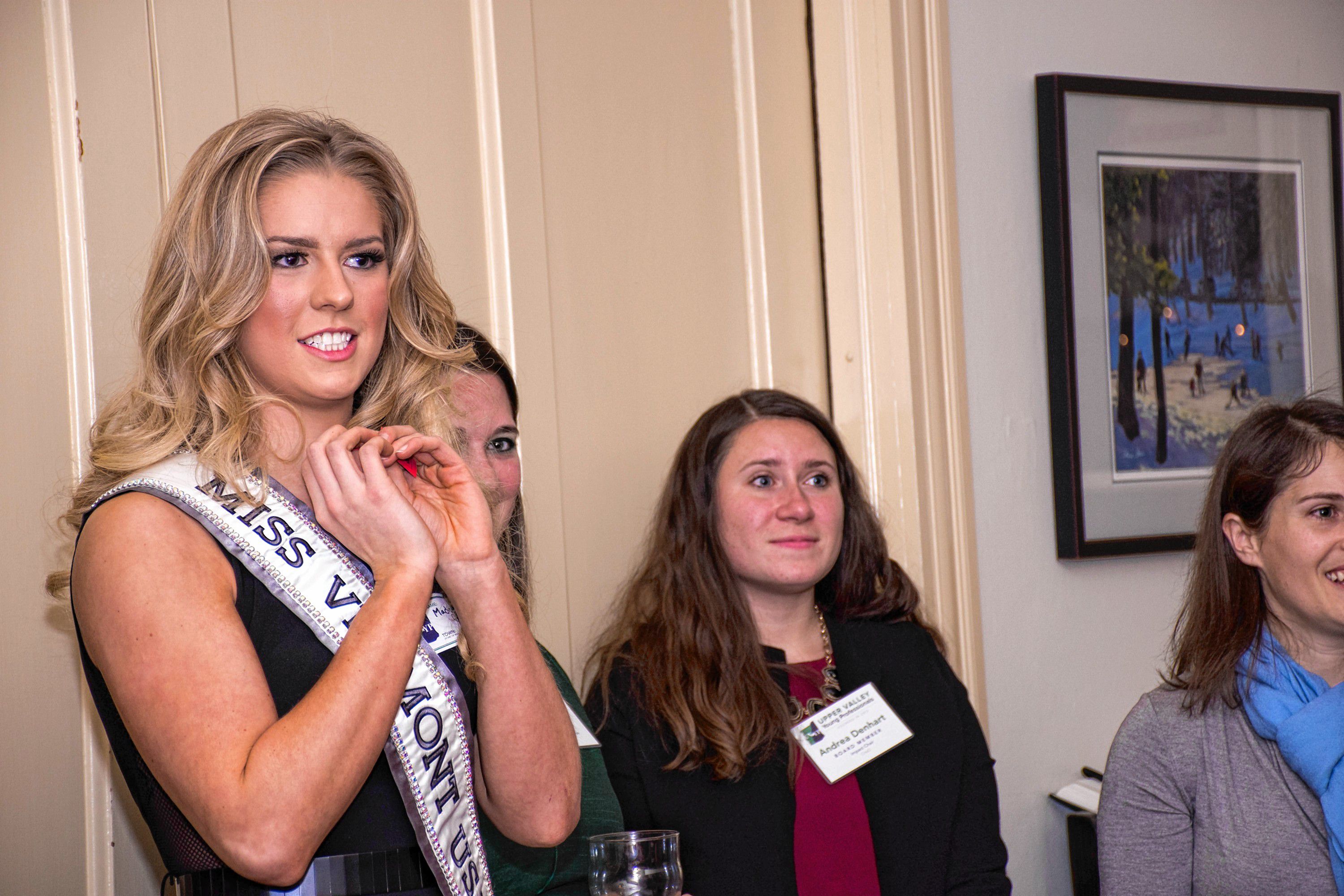Madison Cota, Miss Vermont USA, picks a raffle winner for tickets to Northern Stage at the Upper Valley Young Professionals holiday party and canned food drive at the Norwich Inn on Dec. 15. (Nancy Nutile-McMenemy photograph, photosbynanci@comcast.net)