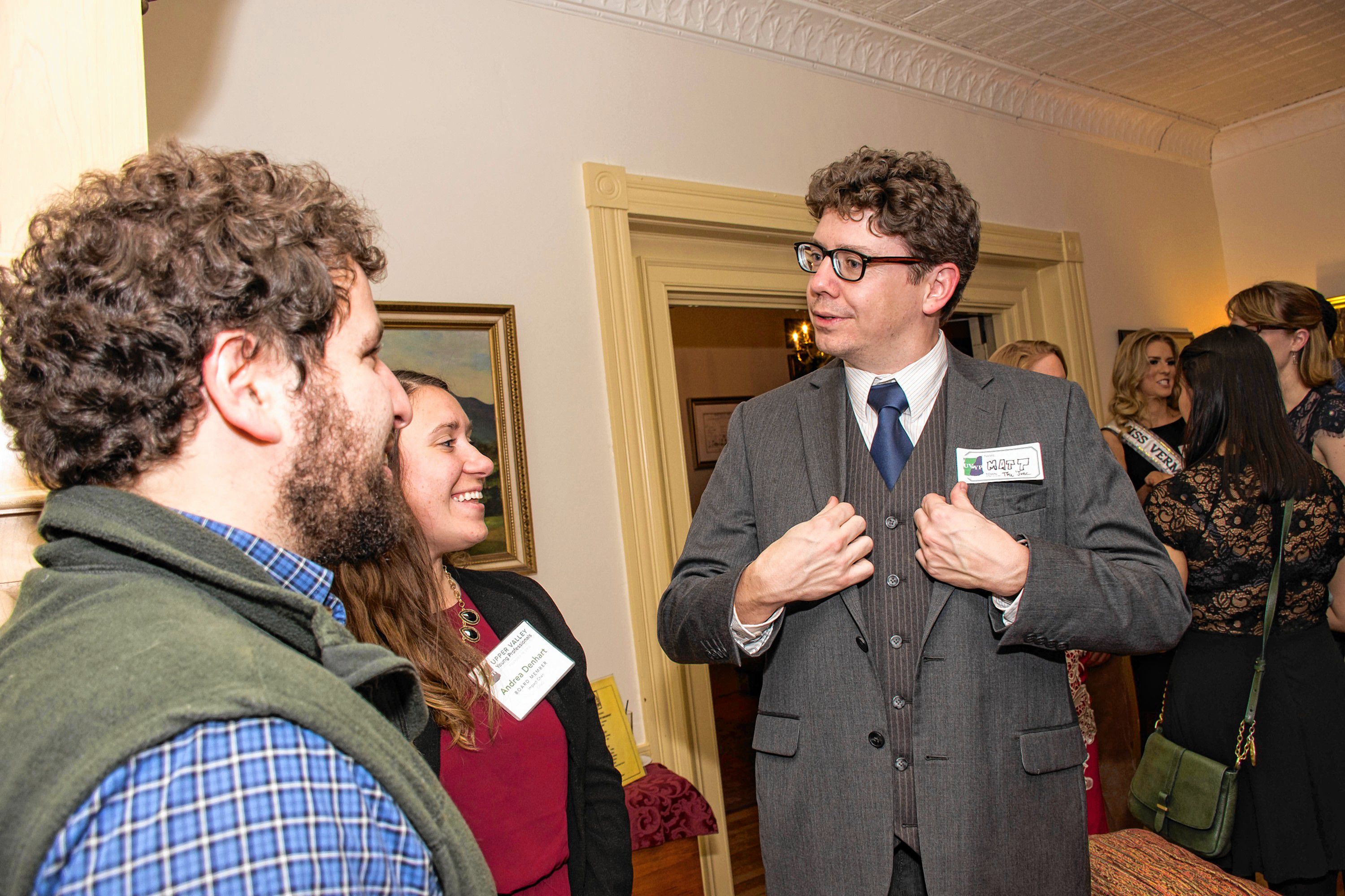 Matt Young, right, of White River Junction, a graphic designer and cartoonist and a co-founder of the Upper Valley Young Professionals, speaks with Jack Kaunders and Andrea Denhardt at the group's holiday party and canned food drive at the Norwich Inn on Dec. 15. (Nancy Nutile-McMenemy photograph, photosbynanci@comcast.net)