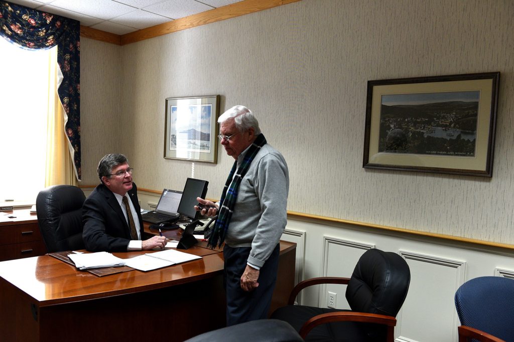 Above left: Stephen Theroux, outgoing Lake Sunapee Bank chief executive. Above right: William McIver, former chief operating officer for Lake Sunapee Bank, now serves as regional vice president with the bank’s new owner, Bar Harbor Bankshares.Left: Theroux speaks with Stephen Ensign in Theroux’s office in Newport. Ensign preceded Theroux as Lake Sunapee Bank’s president and CEO.