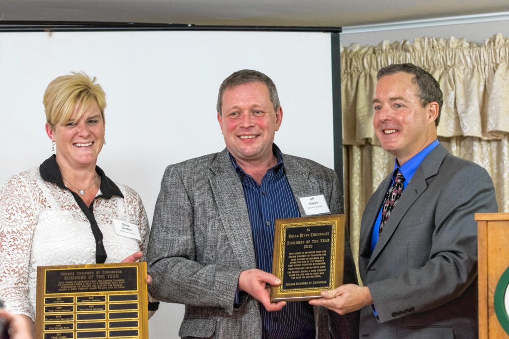 Grace Zambon and Jeff Moore, of Wells River Chevrolet, accept the Cohase Chamber of Commerce Business of the Year award from Erik Volk, right, the chamber's executive director, at the chamber’s recent annual meeting.