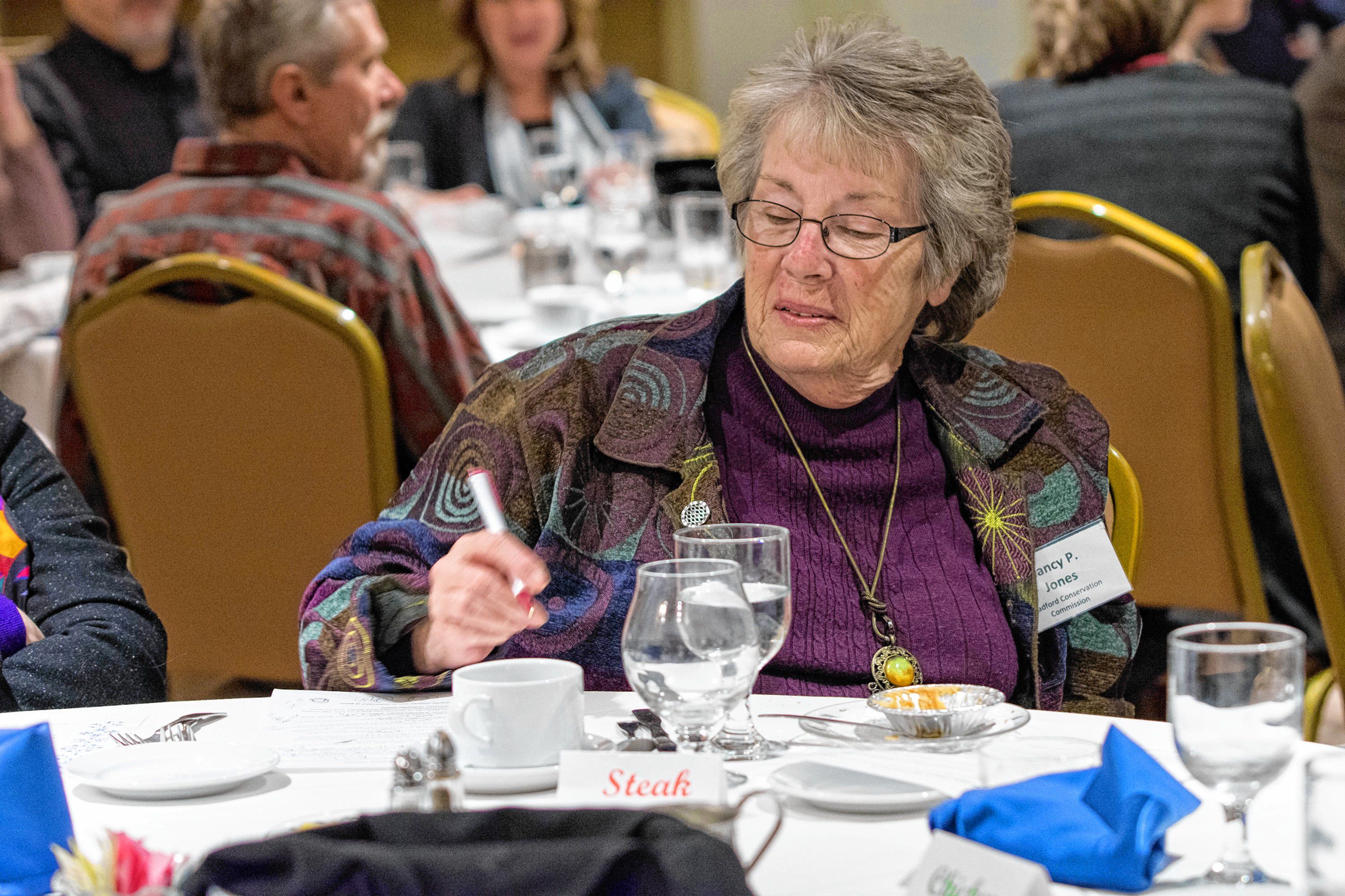 Cohase Chamber of Commerece member Nancy P. Jones, of the Bradford, Vt., Conservation Commission, looks over her answers to the trivia game during the chamber's annual meeting, held Jan. 23 at the Lake Morey Resort in Fairlee. (Nancy Nutile-McMenemy photograph, www.photosbynanci.com)