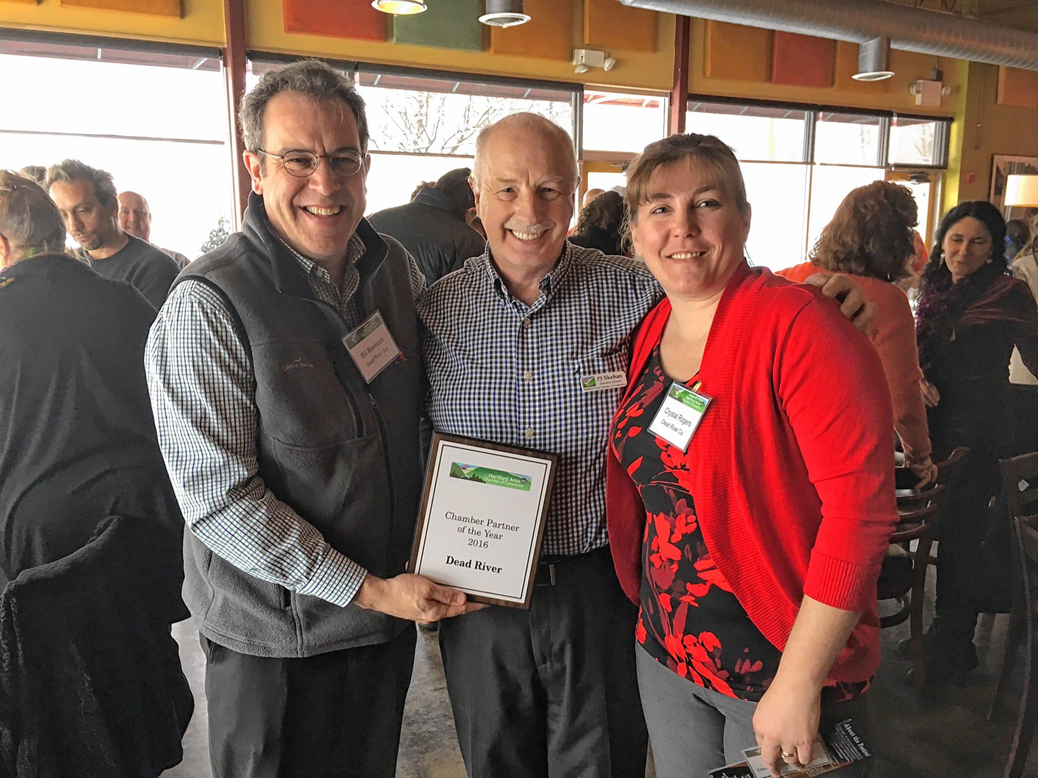 : AWARD WINNERS  Bill Blaiklock, left, and Crystal Rogers, right, of Dead River Co., accept the Community Business of the Year award from P.J. Skehan of the Hartford Area Chamber of Commerce.