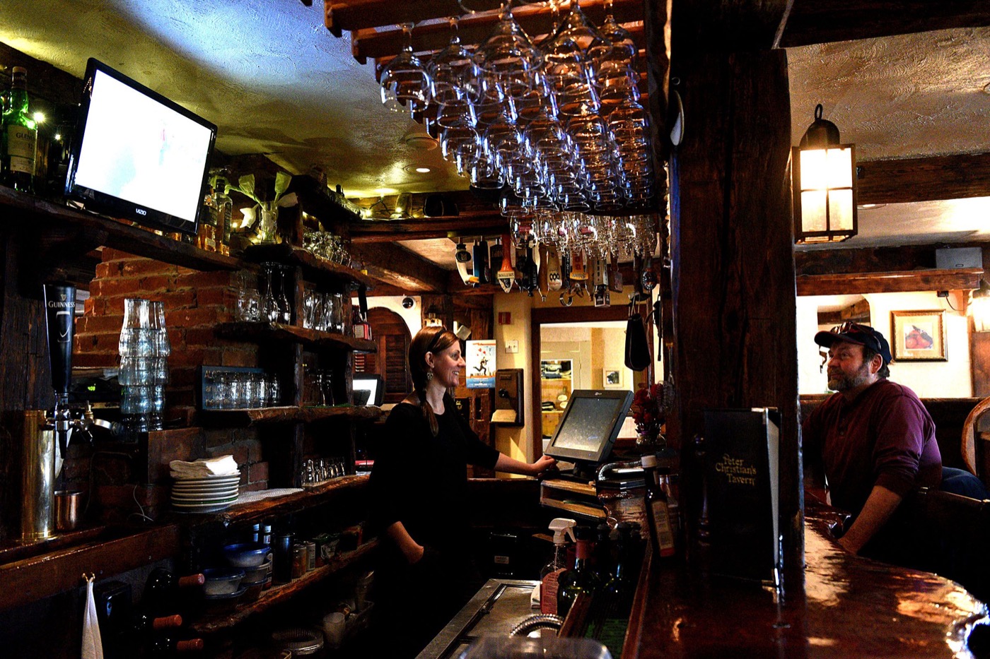 Peter Christian’s Tavern bartender Kati Lannon chats with customer Jay MacArthur, of Andover, N.H., on March 2, 2017, in New London, N.H. MacArthur said he has been through five owners of the tavern. (Valley News - Jennifer Hauck) Copyright Valley News. May not be reprinted or used online without permission. Send requests to permission@vnews.com.