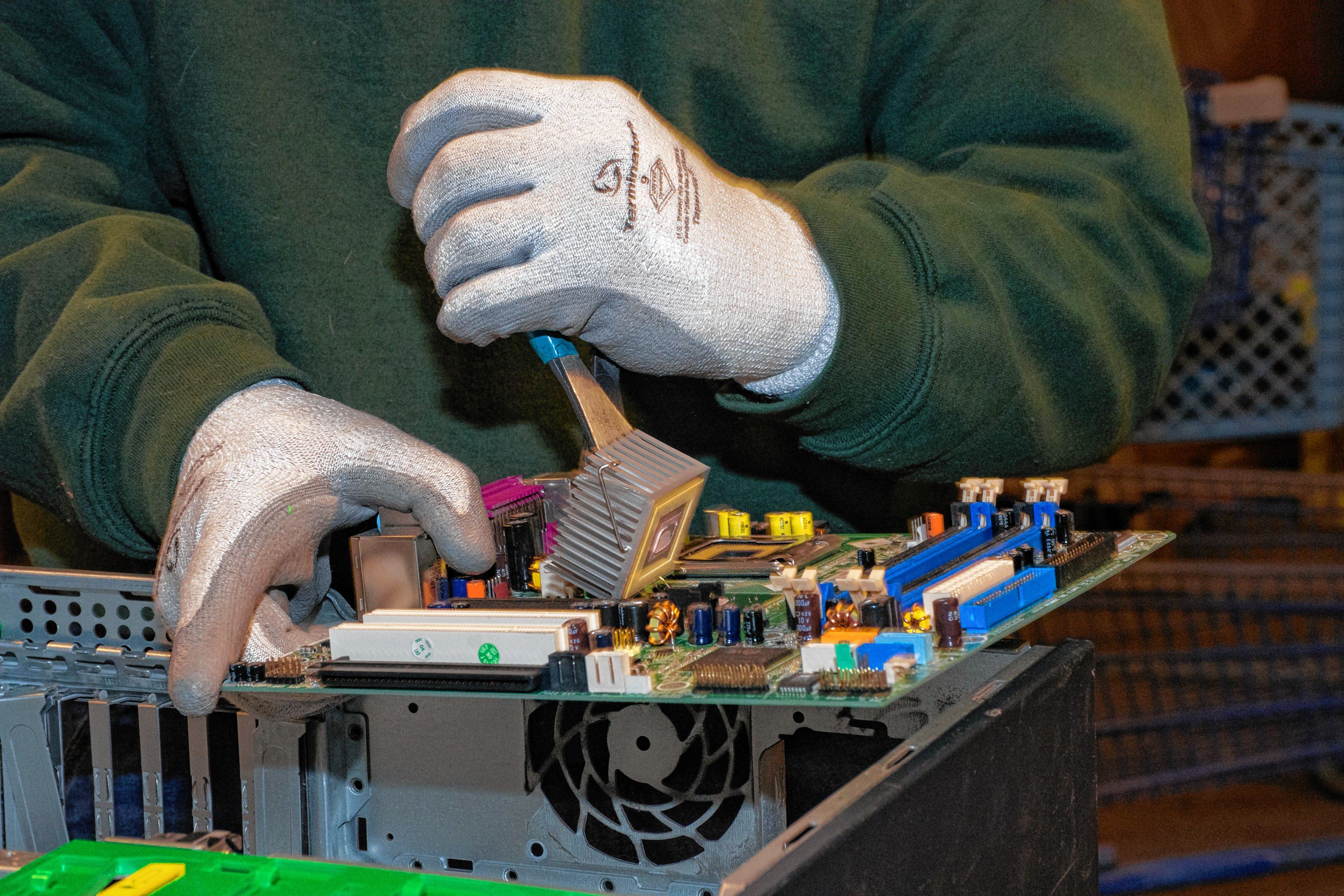 Ken picks apart a motherboard. Nancy Nutile-McMenemy photograph