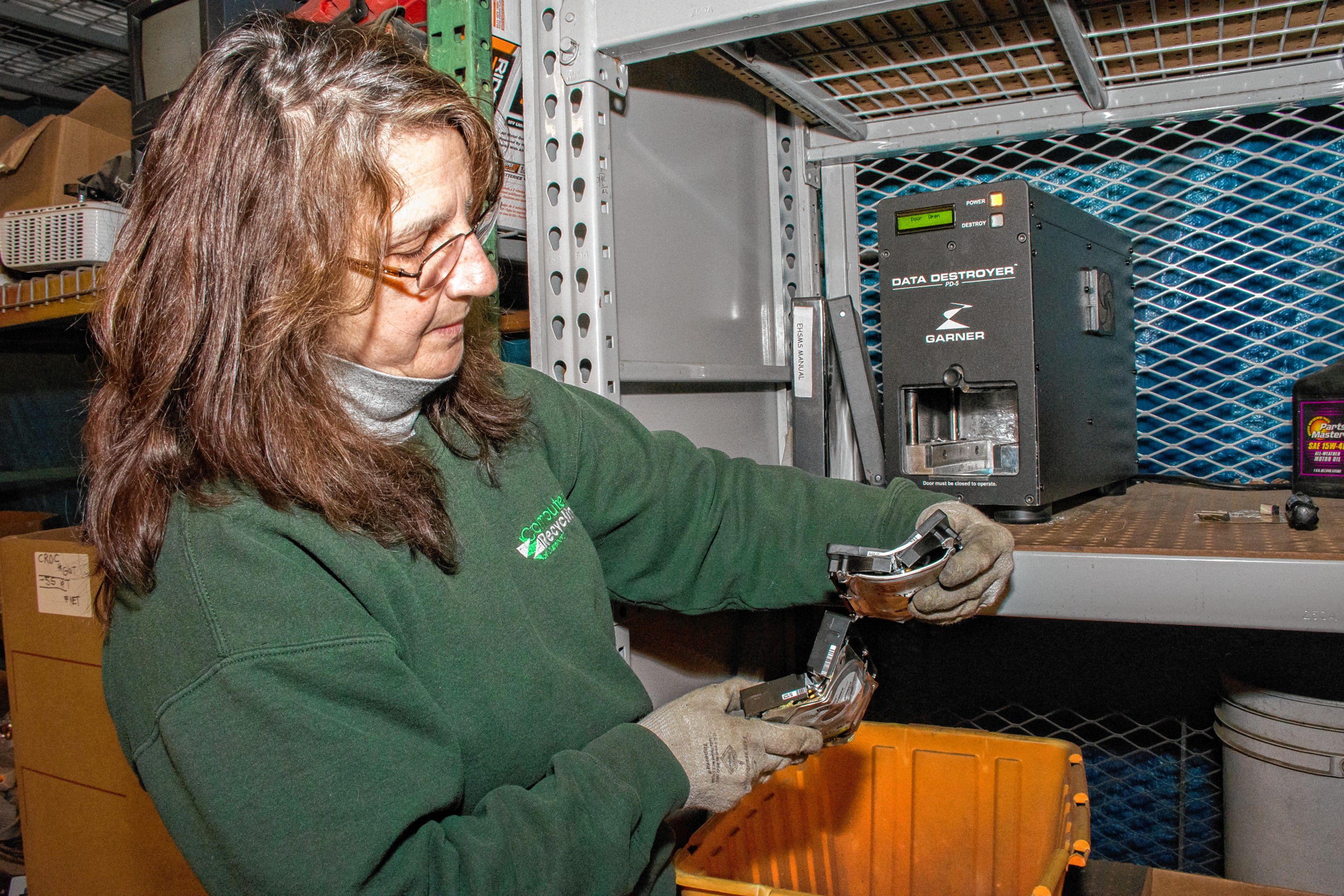 Joyce removes two more destroyed drives. Nancy Nutile-McMenemy photograph