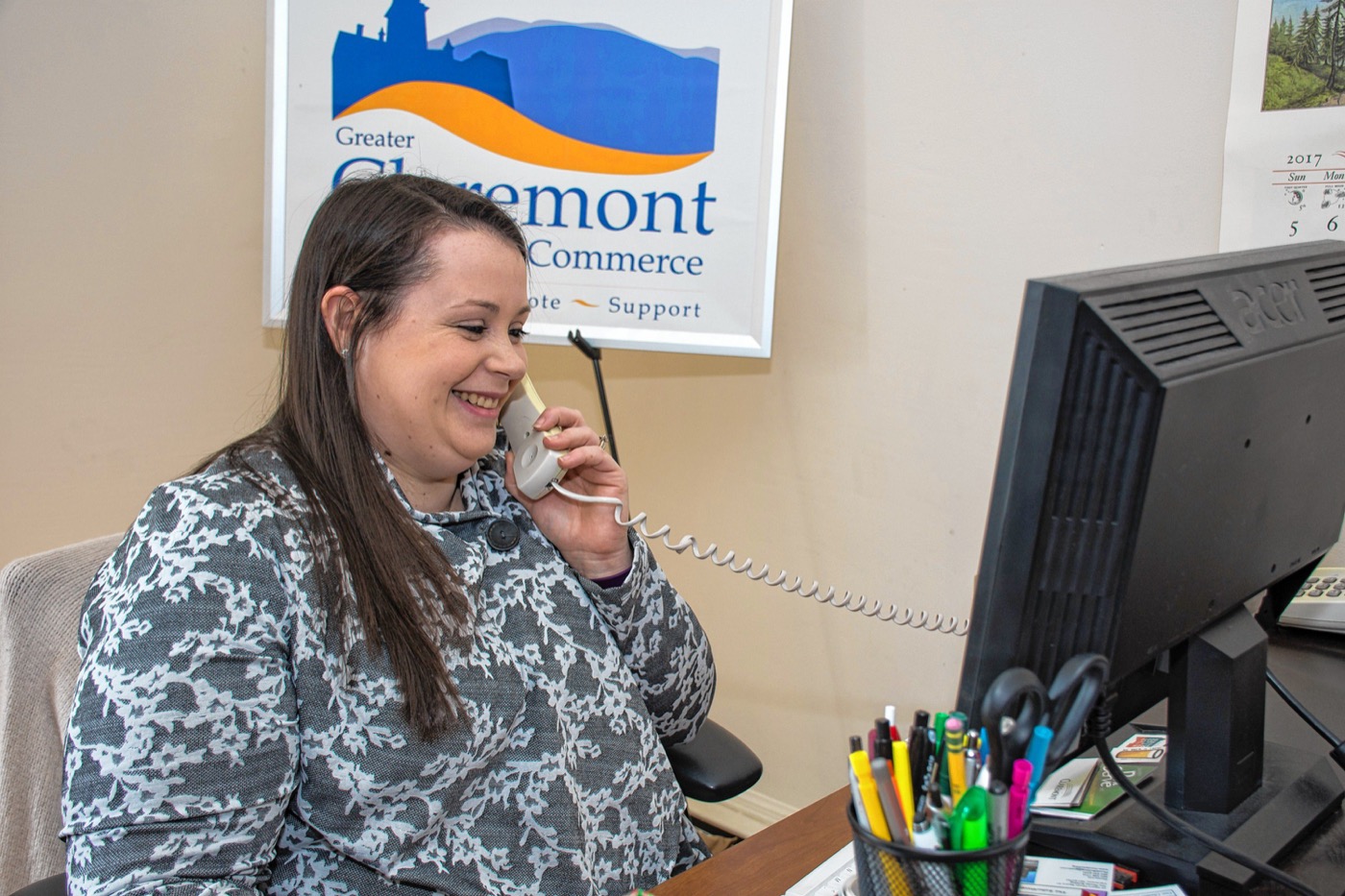 Elyse Crossman on the phone. The Greater Claremont Chamber of Commerce  has 150 members. Nancy Nutile-McMenemy photograph