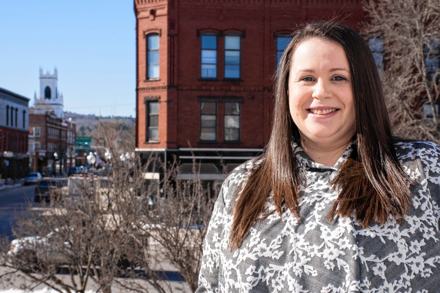 : CLAREMONT’S LEADING LADYElyse Crossman, the executive director of the Greater Claremont Chamber of Commerce, on the balcony outside of her office overlooking the city’s Opera House Square.