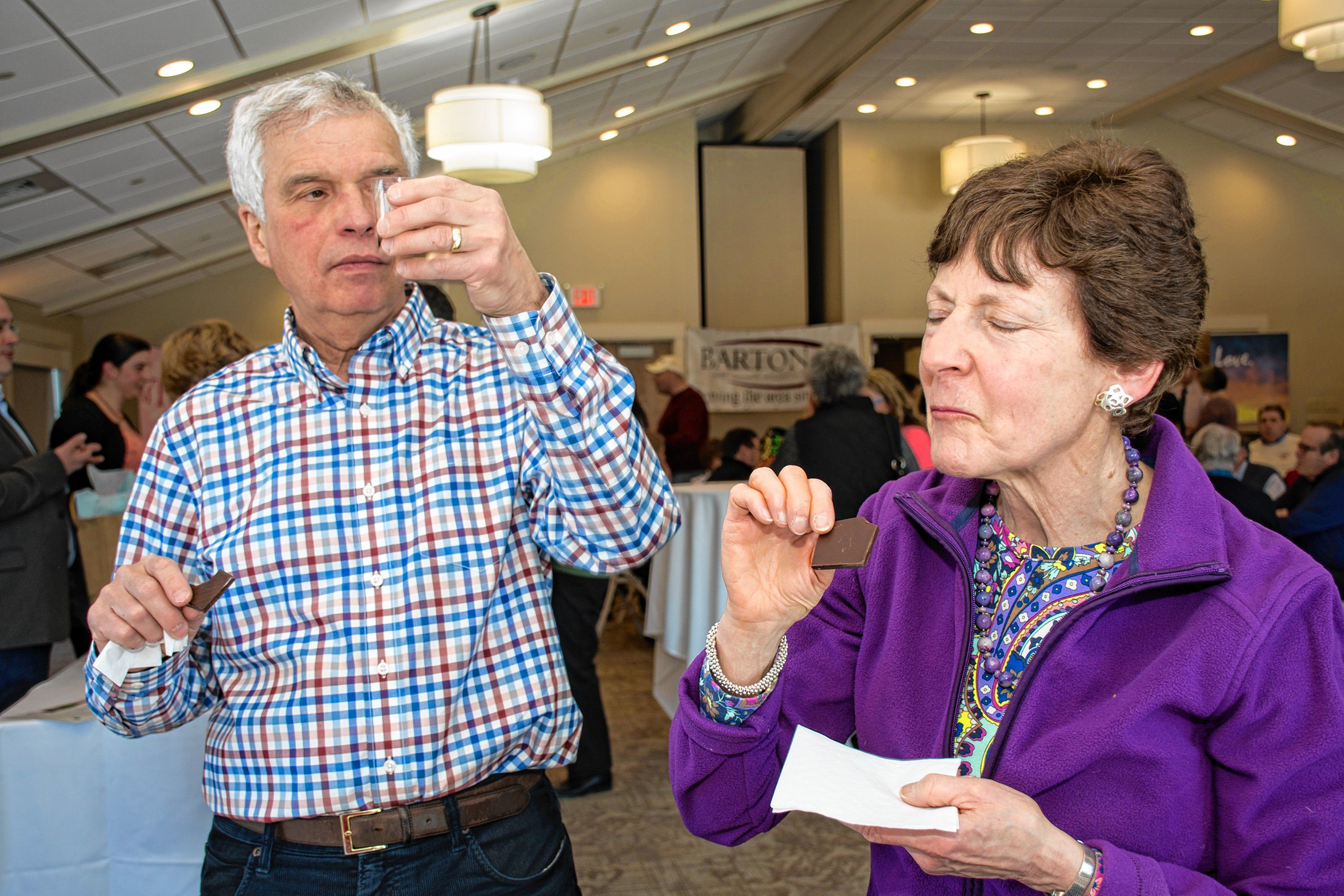 Milton and Rhonda Weinstein of Eastman and Boston enjoy the paired wine and chocolates at the Lindt table. Nancy Nutile-McMenemy photograph