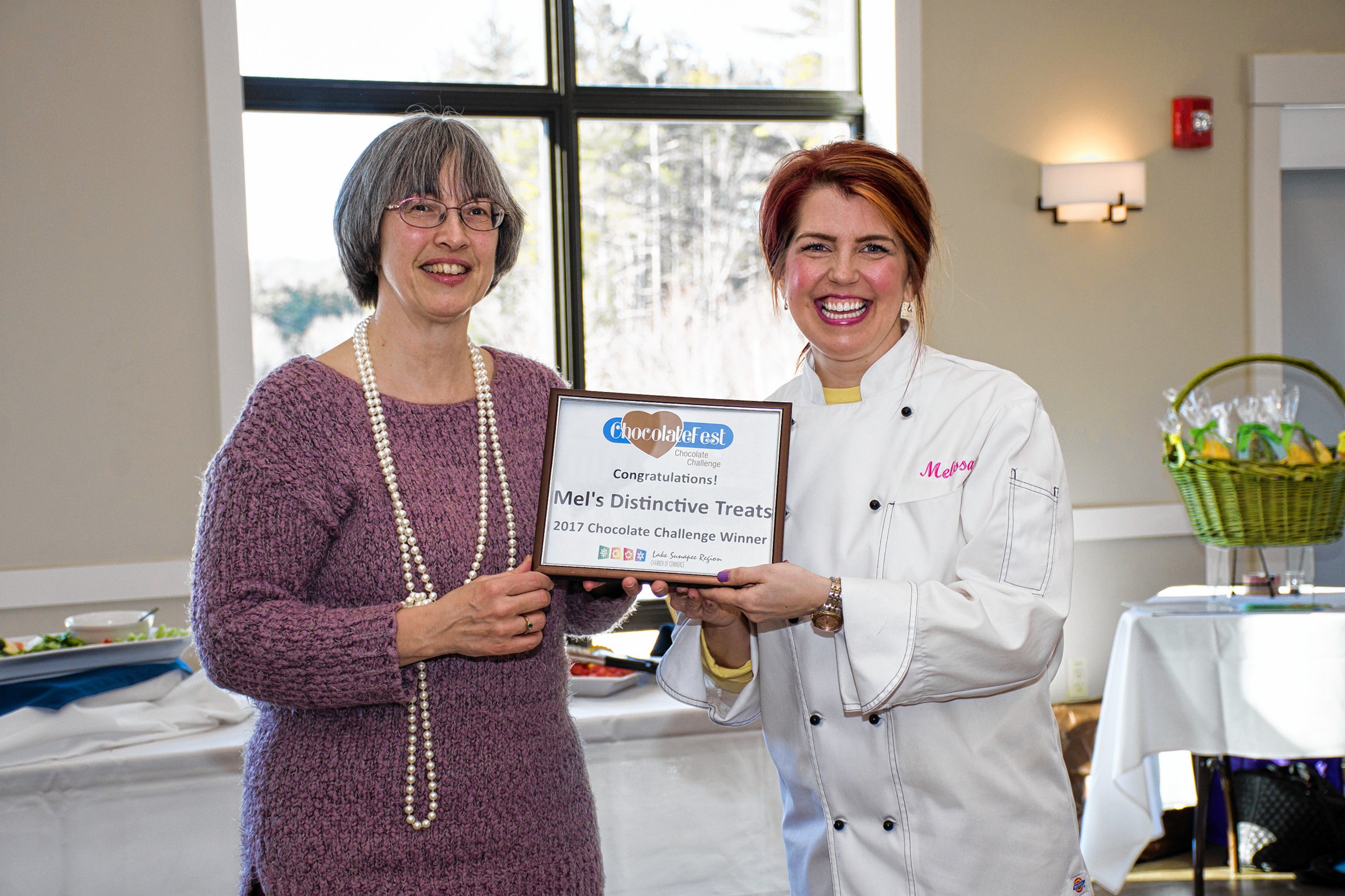 With the votes tallied, Lorie McClory, left, marketing and communications director of Eastman and co-chair of ChocolateFest announces Mel's Distinctive Treats as the 2017 Winner of the Chocolate Challenge. Nancy Nutile-McMenemy photograph