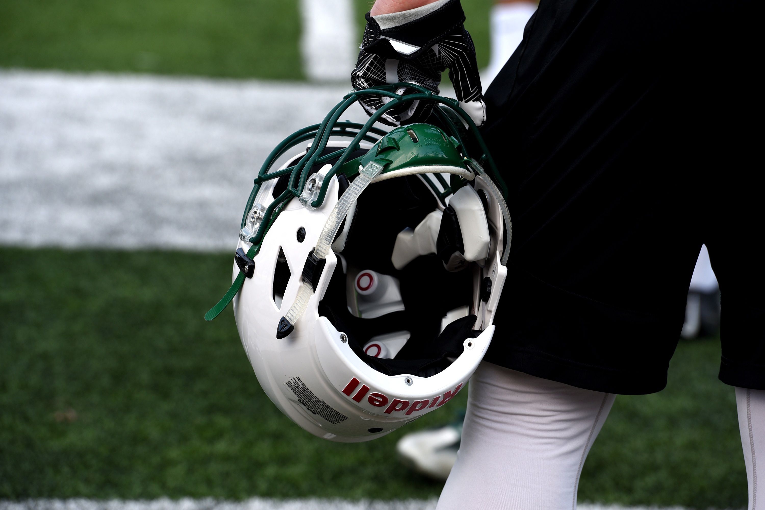 A Dartmouth football player watches from the sideline during a practice in Hanover, N.H, on April 28, 2017. This particular helmet has sensors in it.(Valley News - Jennifer Hauck) Copyright Valley News. May not be reprinted or used online without permission. Send requests to permission@vnews.com.