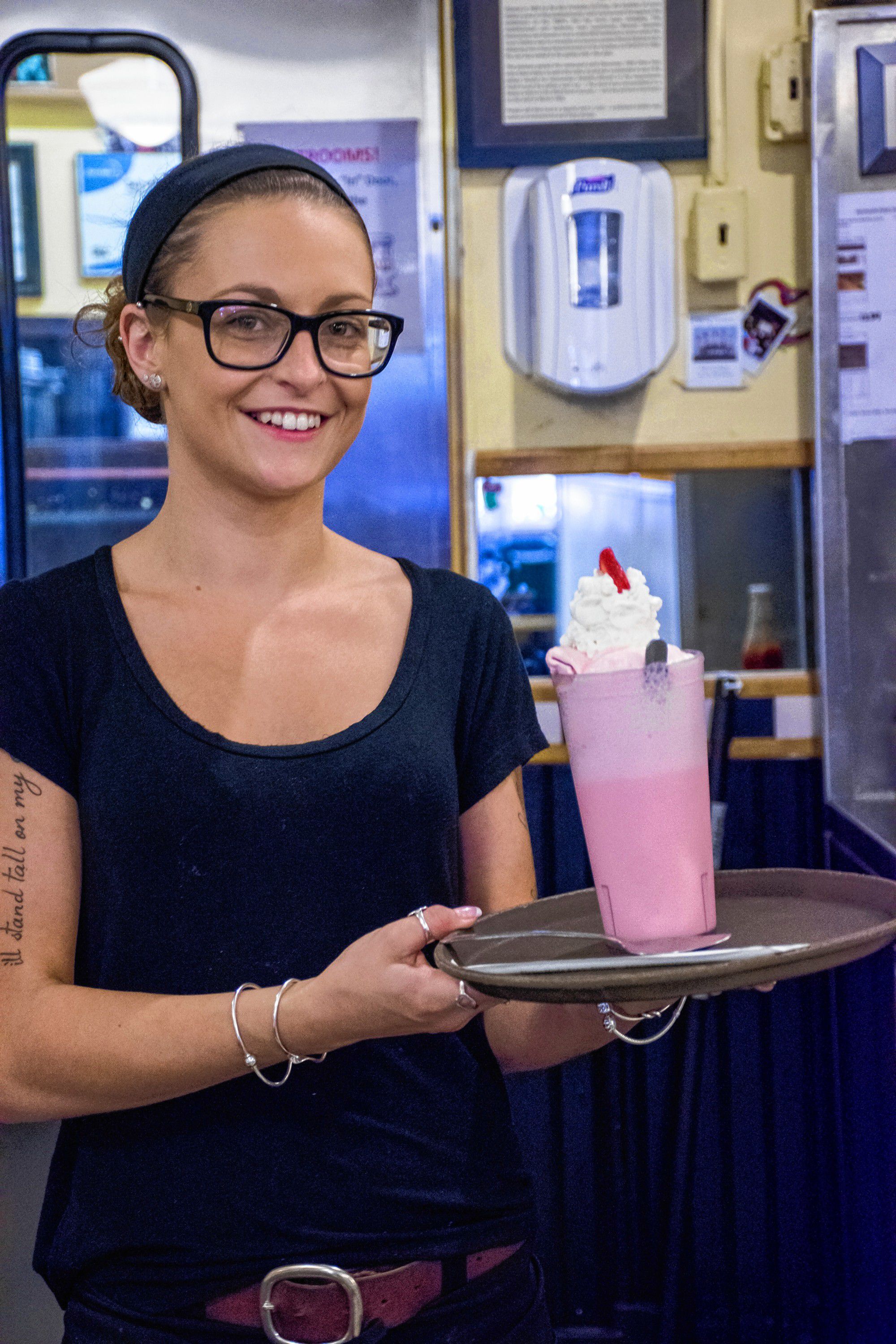 After her mom, Jenny Lavoie made a strawberry milkshake, Hayley Armstrong makes the delivery. Nancy Nutile-McMenemy photograph.