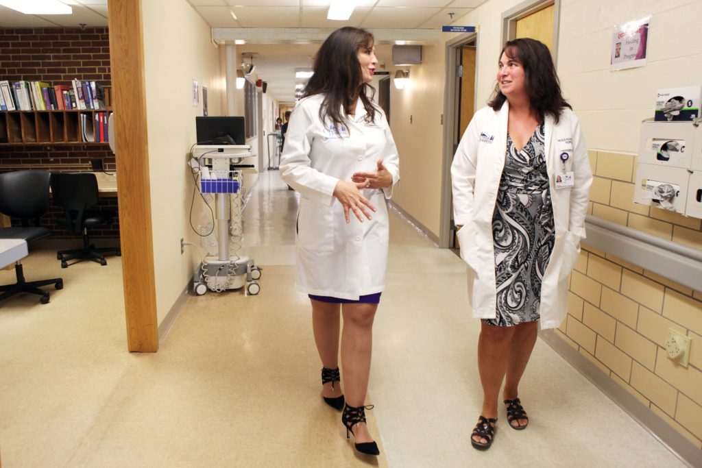 Cottage Hospital CEO Maria Ryan, left, speaks with nurse practitioner Nicole Houston on Wednesday, June 14, 2017, in Woodsville, N.H. (Valley News - Jovelle Tamayo) Copyright Valley News. May not be reprinted or used online without permission. Send requests to permission@vnews.com.