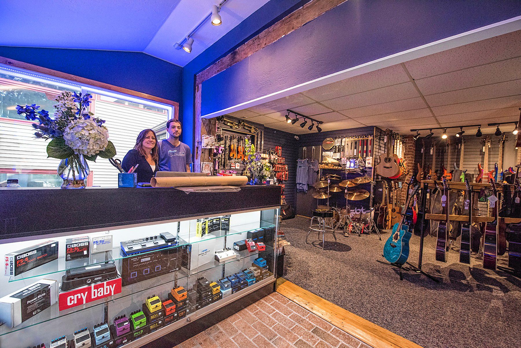 Barb McKelvy, left, and her business partner, Tyler Geno, have reopened Blue Mountain Guitar in an alcove of shops on Main Street in New London, directly across from Colby-Sawyer College. (Courtesy photograph)