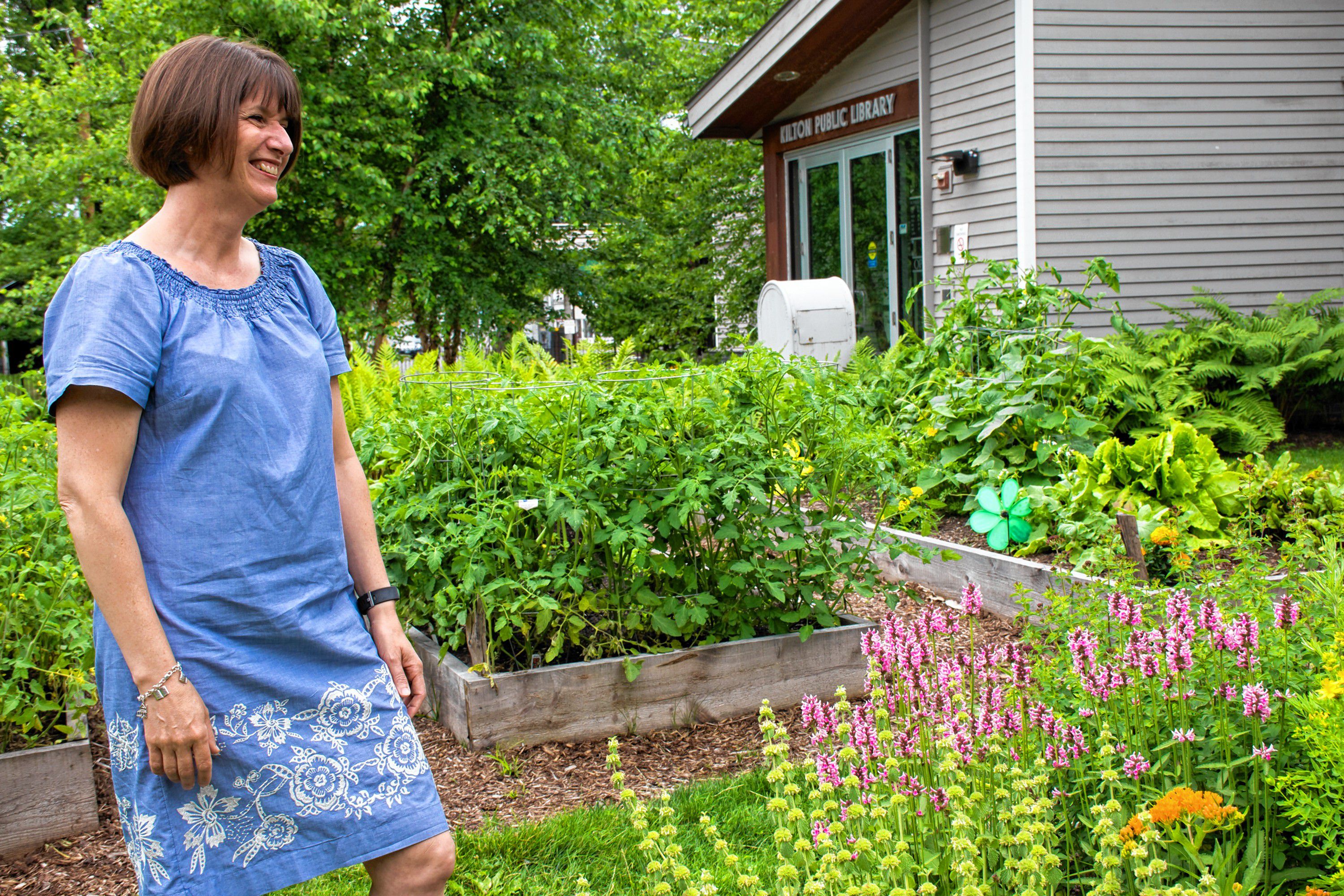 The library boasts a community garden on the site of the former wood pellet silo. On a quick break, Amy Lappin Deputy Director of the Lebanon Public Libraries takes a little time to enjoy some of the wildflowers. Nancy Nutile-McMenemy photograph.