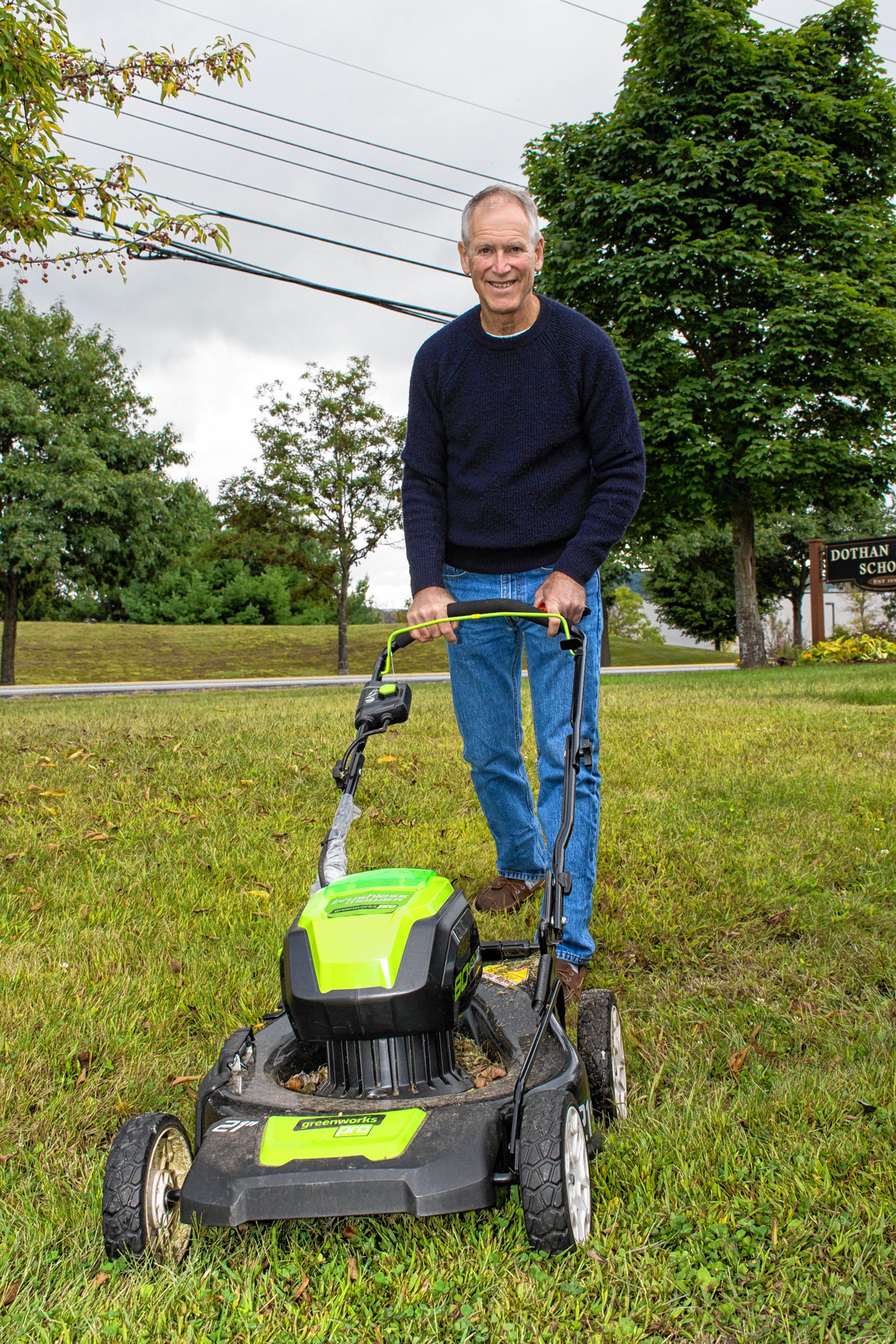 Jamie Hess, a member of the New London (N.H.) Energy Committee, shows off his electric lawnmower on display at the second annual Upper Valley Electric Vehicle Expo on Sept. 9 at Dothan Brook School in Hartford, Vt. (Nancy Nutile-McMenemy photograph)