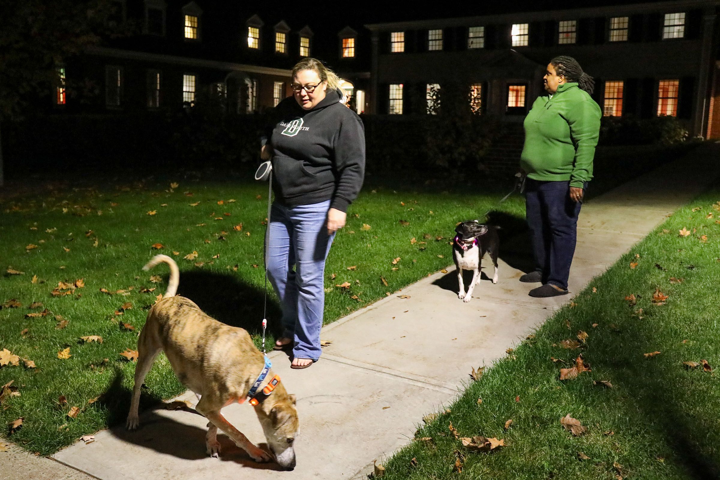 Jen Jones, left, of Hanover, N.H., walks with her wife, Dia Draper, also of Hanover, and their two dogs, Clay, left, and Sally on Monday, Oct. 23, 2017, outside of the Triangle House on the Dartmouth College campus in Hanover, N.H. The couple live at the Triangle House as live-in advisors for LGBTQIA+ students living on campus. (Valley News - Charles Hatcher) Copyright Valley News. May not be reprinted or used online without permission. Send requests to permission@vnews.com