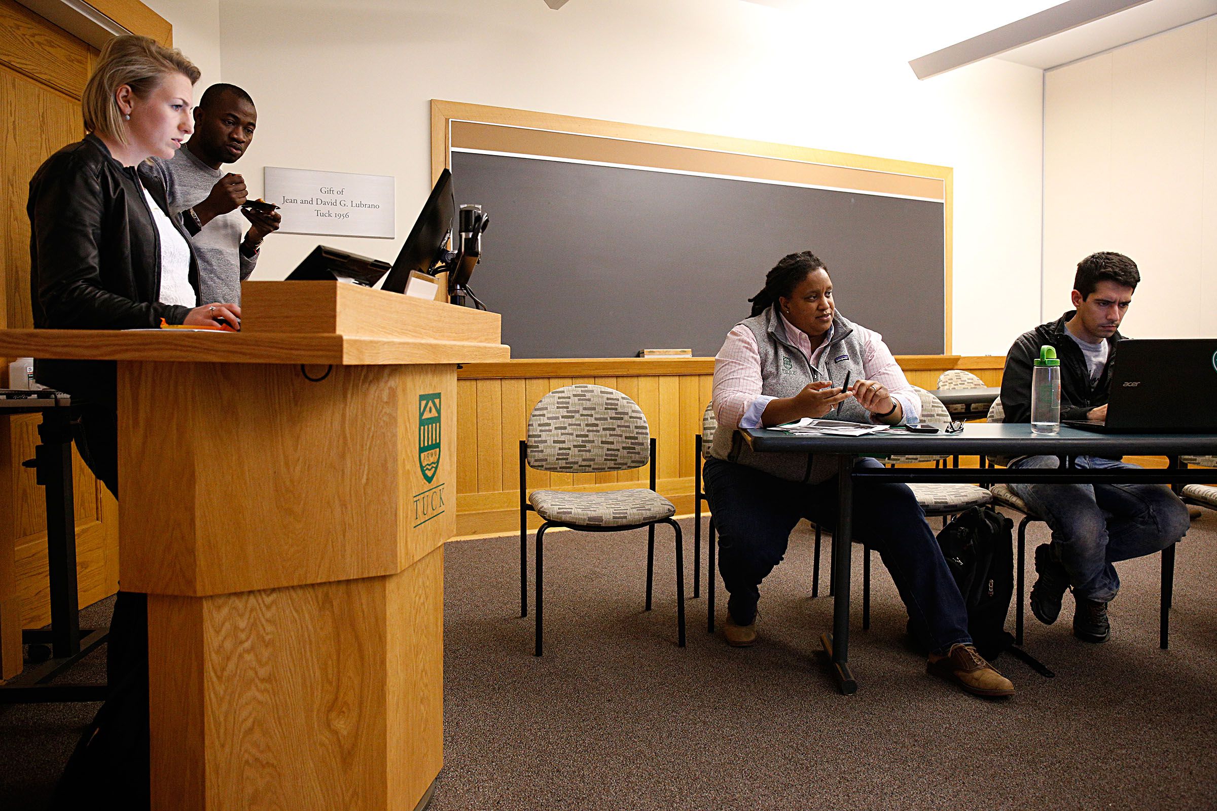 Dia Draper, director of strategic initiatives at the Tuck School of Business, answers questions from second-year students, including from left, Martina Ravelli, Martial Combari and Enrique Curiel, in Hanover, N.H., on Oct. 24, 2017, about their plans for the annual Tuck Diversity Conference held at the school in November. Seven students are co-chairs of the conference, held since 1994 for prospective students. (Valley News - Geoff Hansen) Copyright Valley News. May not be reprinted or used online without permission. Send requests to permission@vnews.com.
