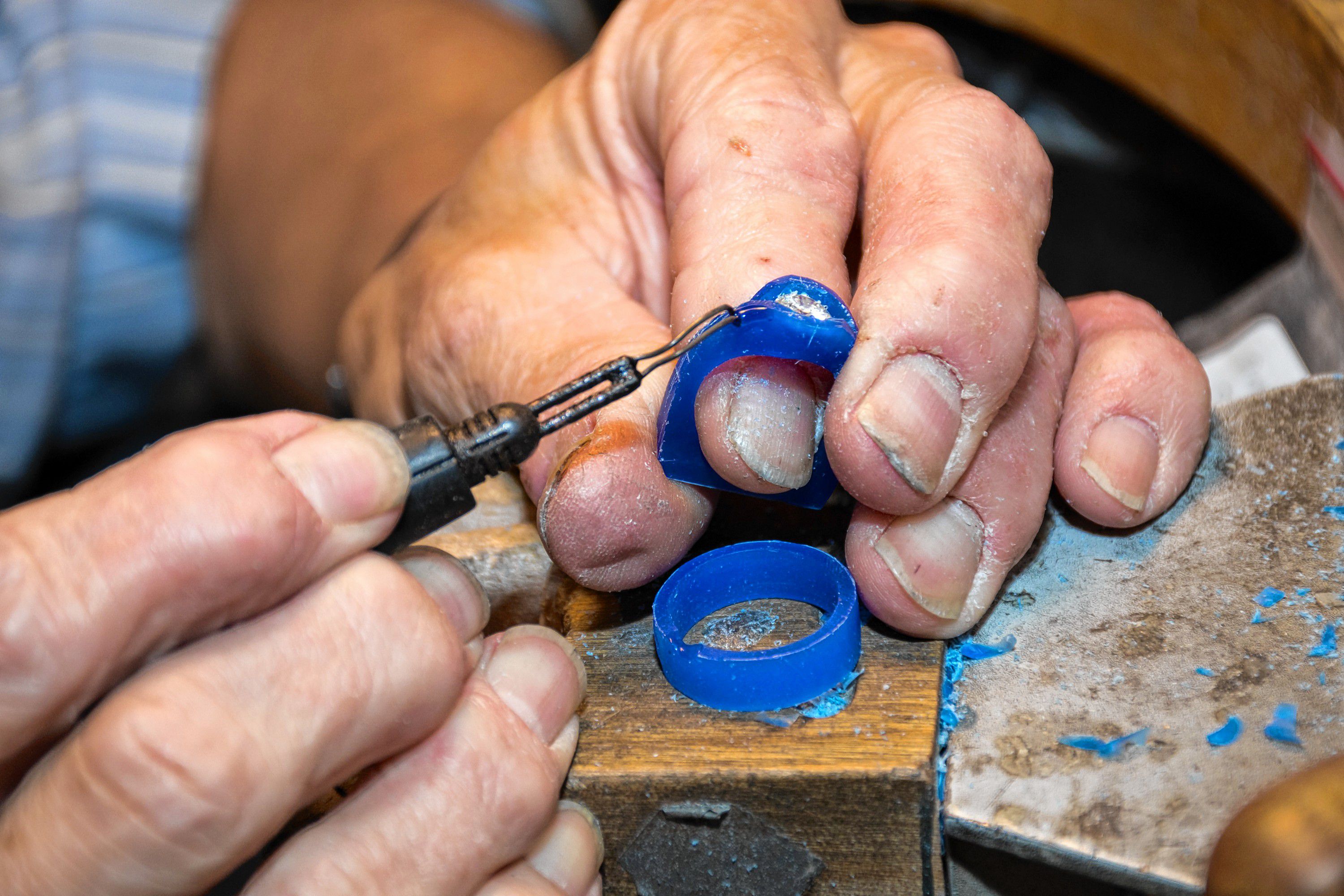 Paul Gross, of Designer Gold in Hanover, N.H., carves wax to create a custom band for a stone being reset for a customer. The wax will eventually be replaced with gold. "I'm old school. Some jewelers have moved to 3-D, not me" said Gross, who has been designing handcrafted jewelry since 1977. (Nancy Nutile-McMenemy photograph)