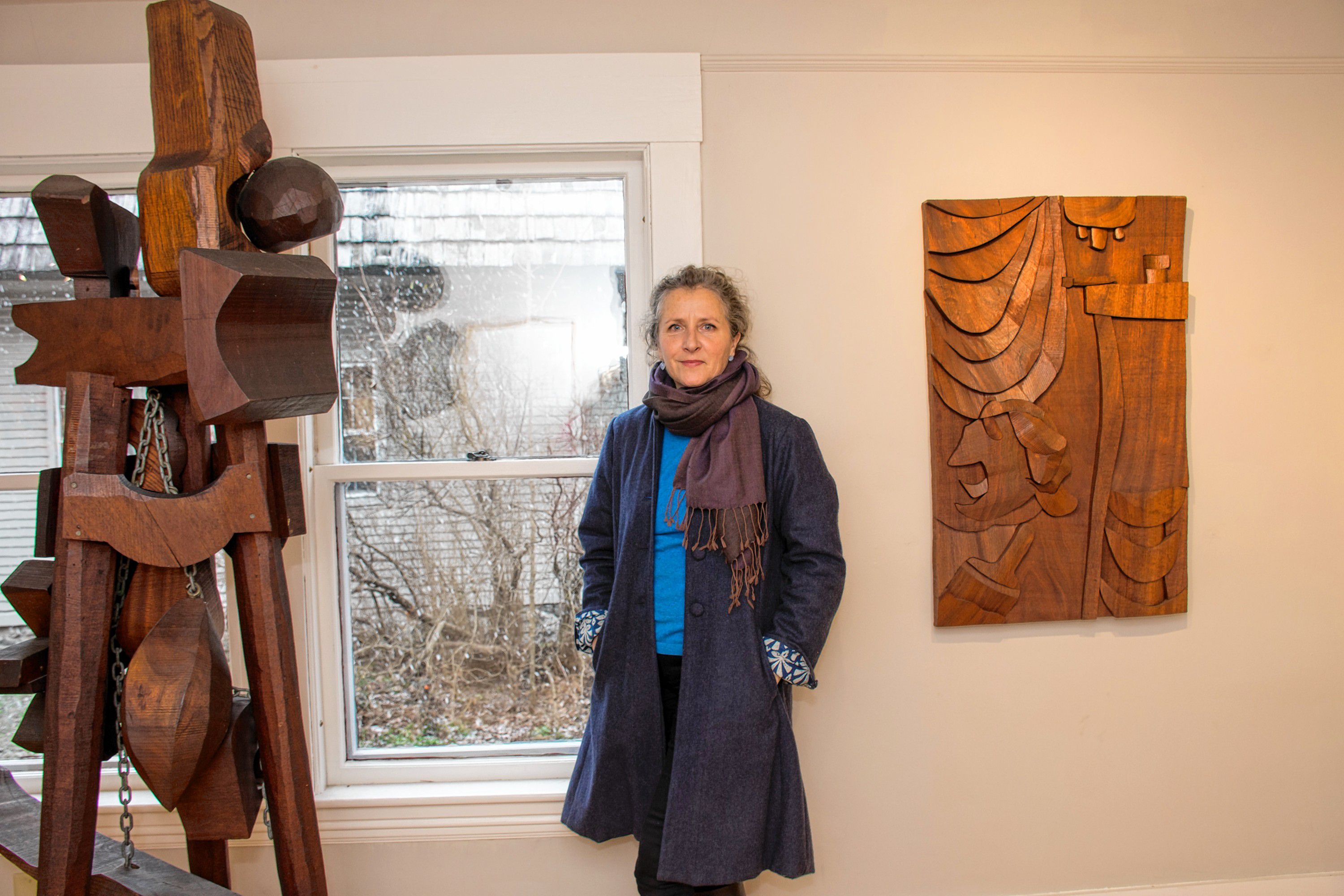 Anni Mackay poses between a couple of pieces created by Hugh Townley. Nancy Nutile-McMenemy photograph.