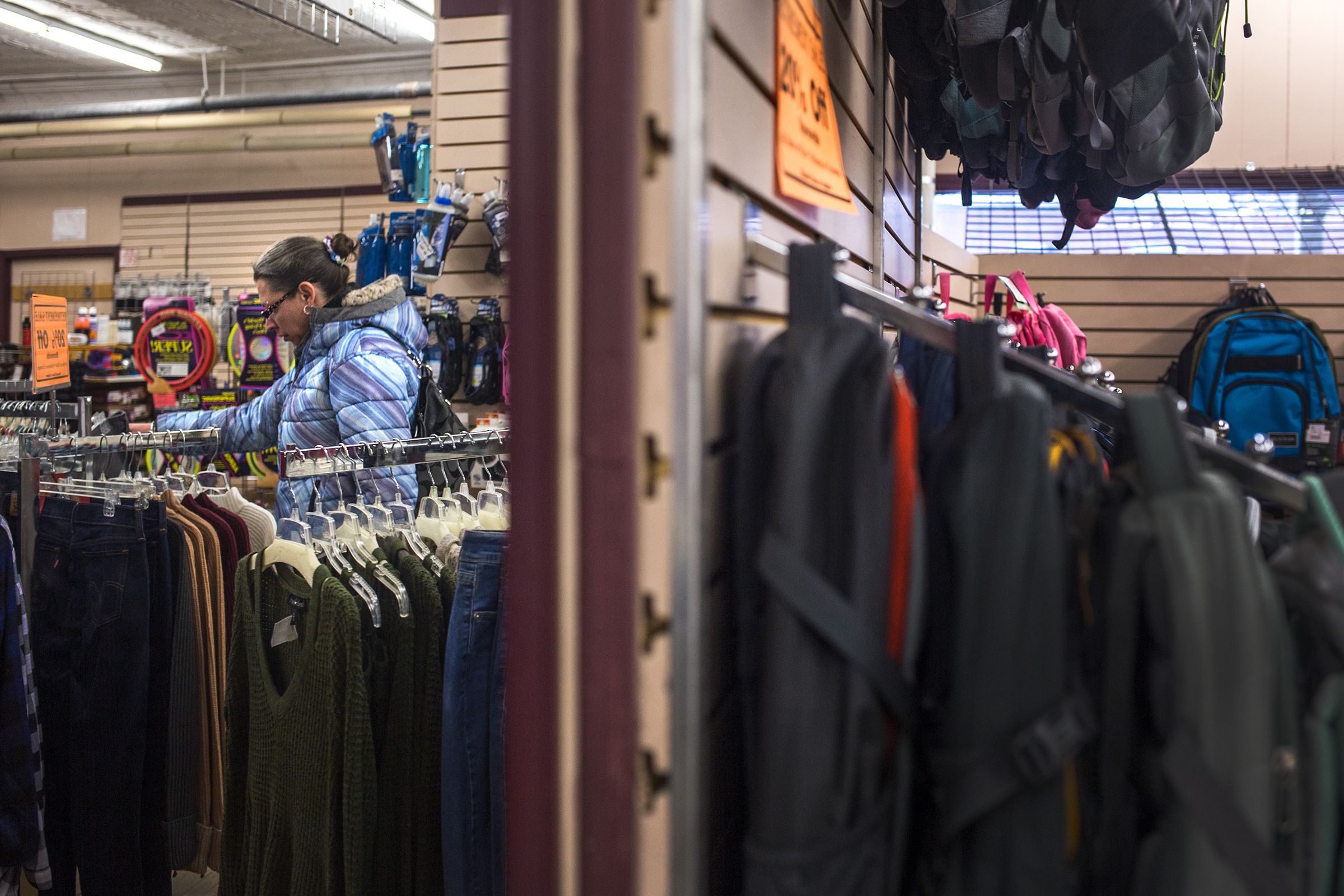 Cori Stackpole, of Newport, N.H., looks at a pair of pants during the closing sale at Hubert's Department Store in Newport on Feb. 1, 2018. Stackpole has been coming to the store since she was a teenager and said it will be sad to see the store go because there is not much in town. (Valley News - Carly Geraci) Copyright Valley News. May not be reprinted or used online without permission. Send requests to permission@vnews.com.