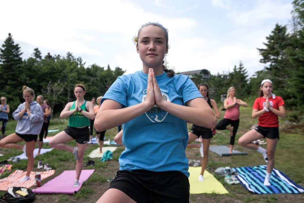 Rayna Tucker, 14, of Springfield, N.H., hiked up Mount Sunapee in Newbury, N.H., with the Kearsarge girls soccer team to participate in a yoga class Wednesday, July 11, 2018.  (Valley News - James M. Patterson) Copyright Valley News. May not be reprinted or used online without permission. Send requests to permission@vnews.com.