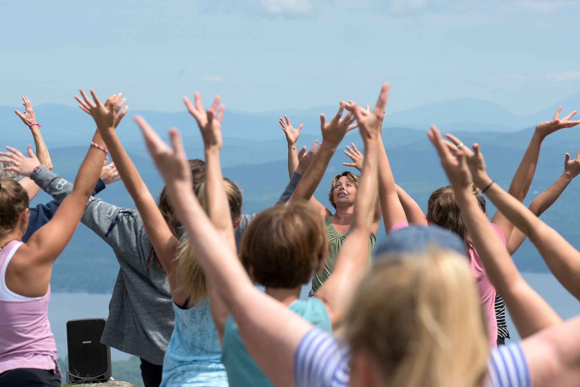 Yoga instructor Leigh Ann Root leads sun salutations durig her yoga class at the top of Mount Sunapee in Newbury, N.H., Wednesday, July 11, 2018. (Valley News - James M. Patterson) Copyright Valley News. May not be reprinted or used online without permission. Send requests to permission@vnews.com.