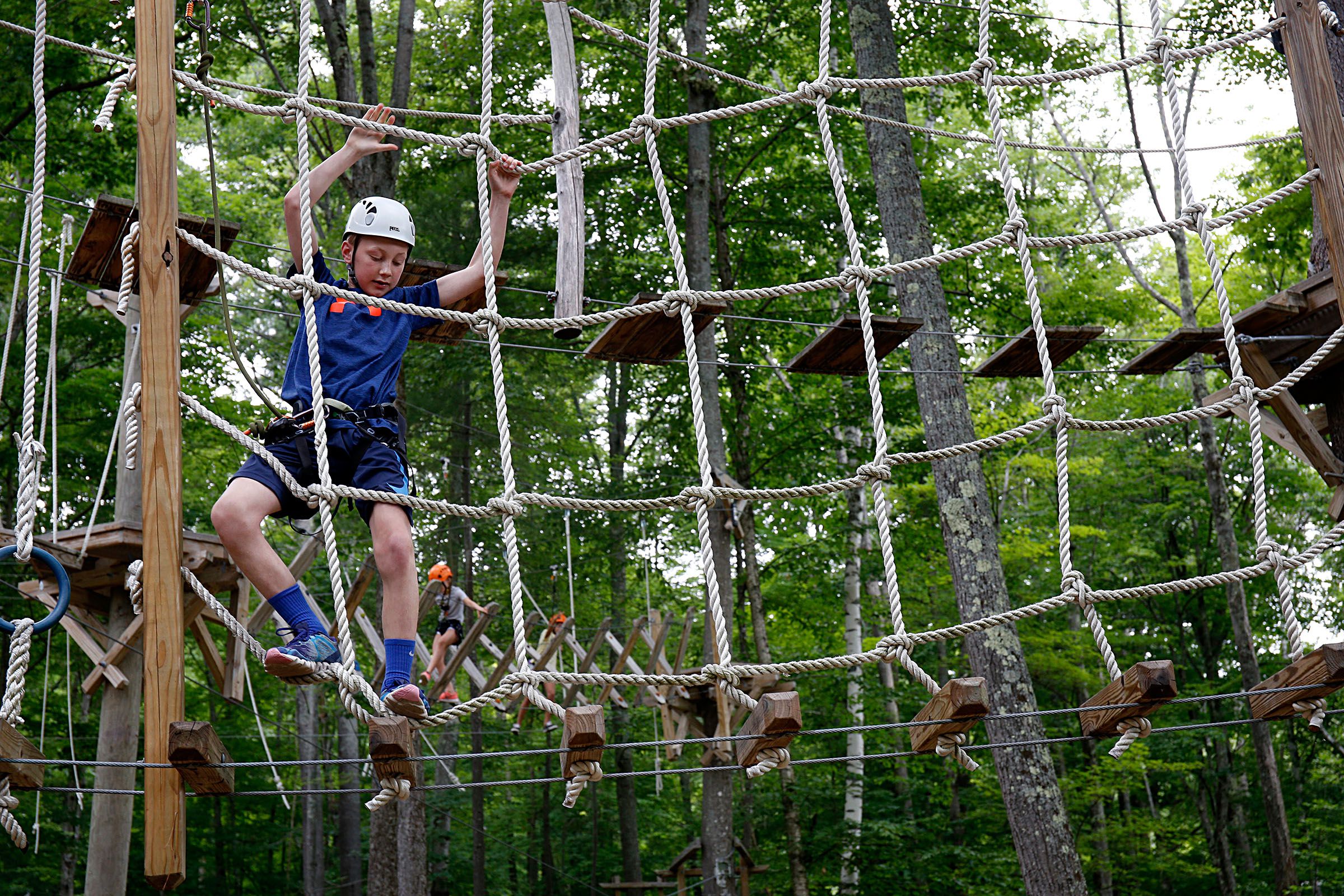 Ryan Flaherty, 12, of Foxborough, Mass., maneuvers through the Aerial Challenge Course at Mount Sunapee Resort's Adventure Park in Sunapee, N.H., on July 14, 2018. The resort has added several recreational activities for summertime enjoyment. (Valley News - Geoff Hansen) Copyright Valley News. May not be reprinted or used online without permission. Send requests to permission@vnews.com.